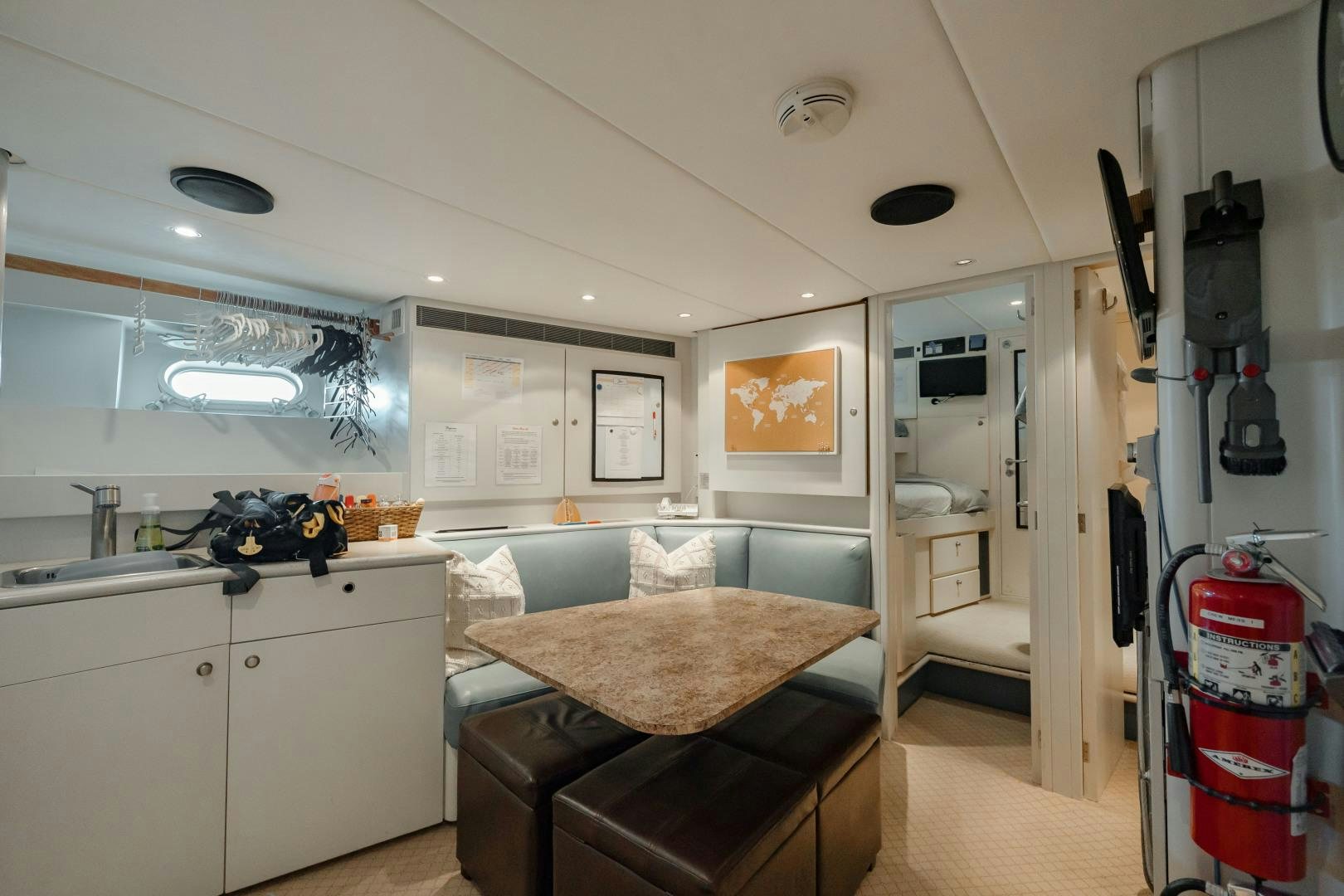 a kitchen with a table and chairs aboard CAPRICE Yacht for Sale
