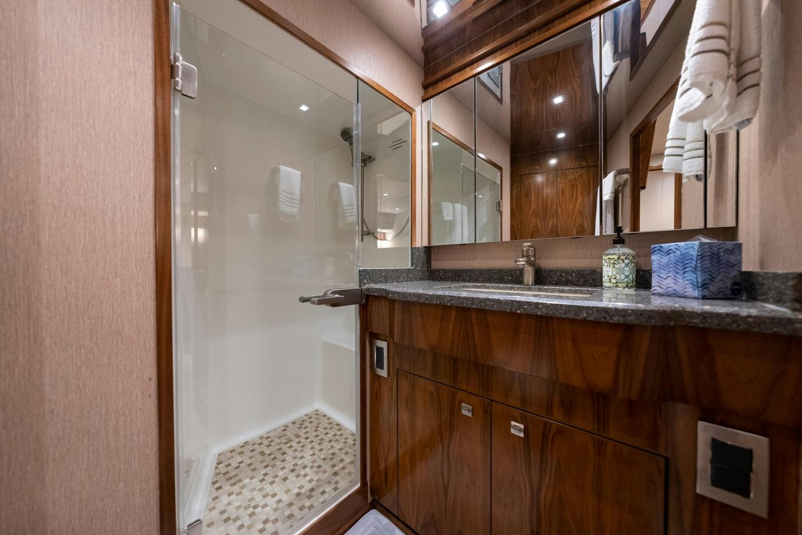 a bathroom with a glass shower aboard SIR' REEL Yacht for Sale