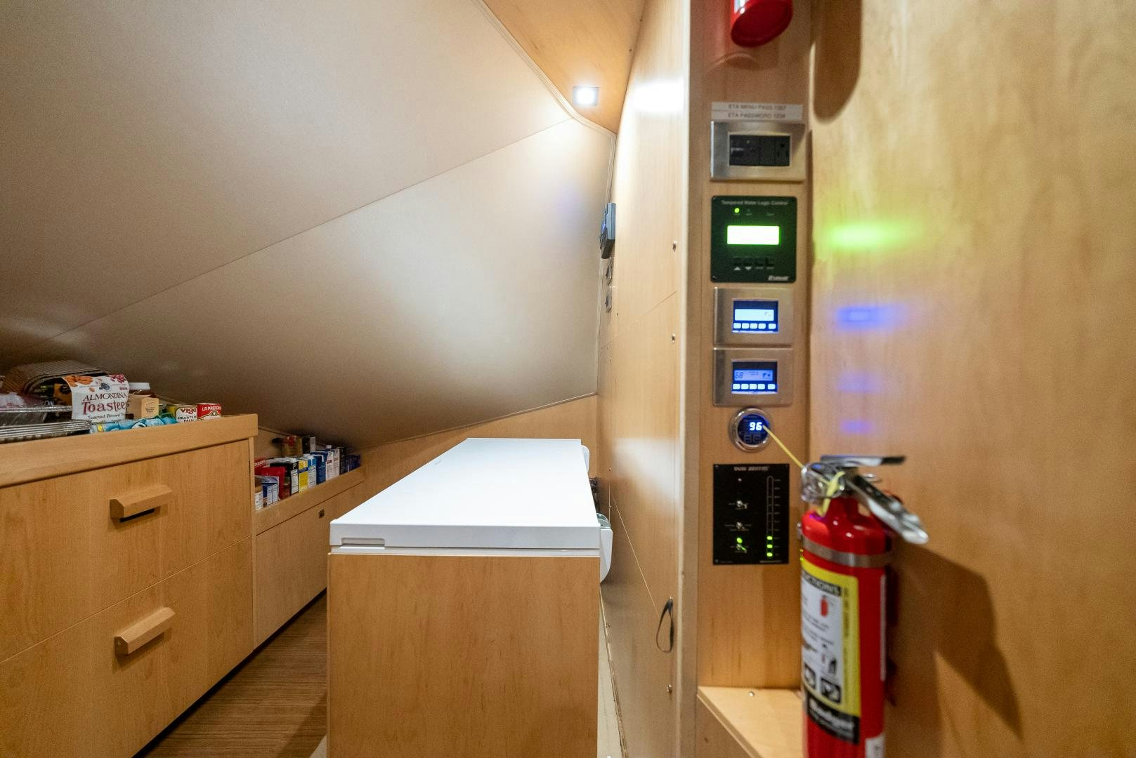 a small refrigerator with a microwave and a bottle of soda aboard SIR' REEL Yacht for Sale