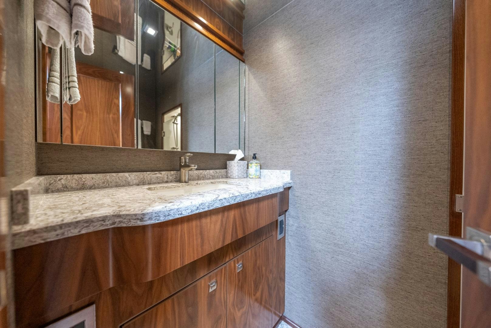 a bathroom with a countertop sink and mirror aboard SIR' REEL Yacht for Sale