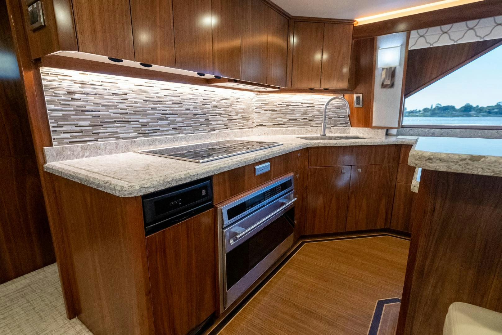 a kitchen with wooden cabinets aboard SIR' REEL Yacht for Sale