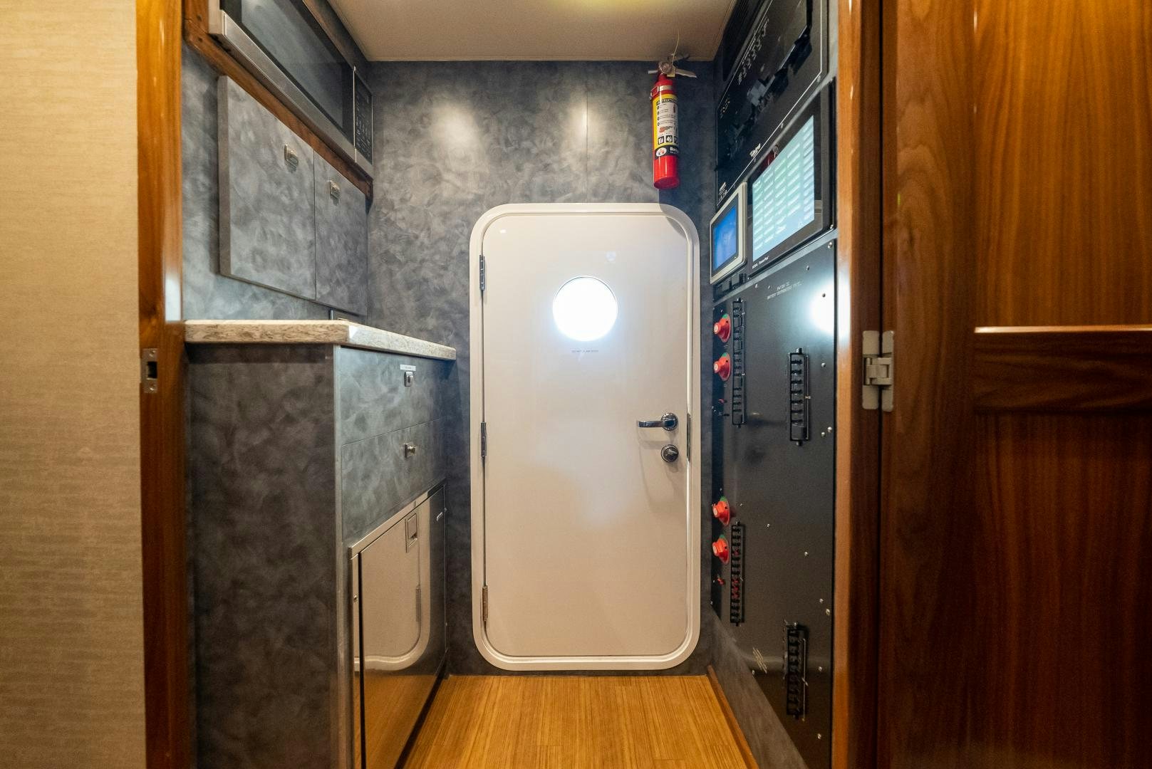 a room with a door and a machine in it aboard SIR' REEL Yacht for Sale