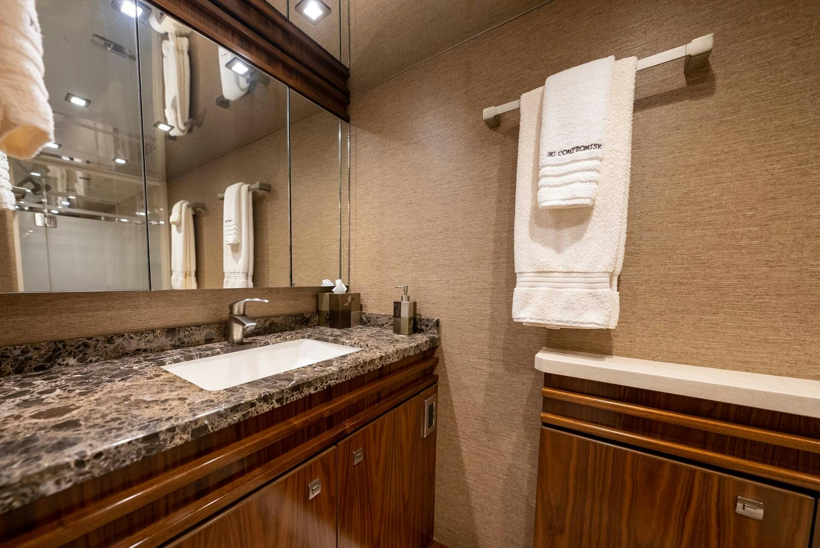 a bathroom with a countertop sink and towels aboard SIR' REEL Yacht for Sale
