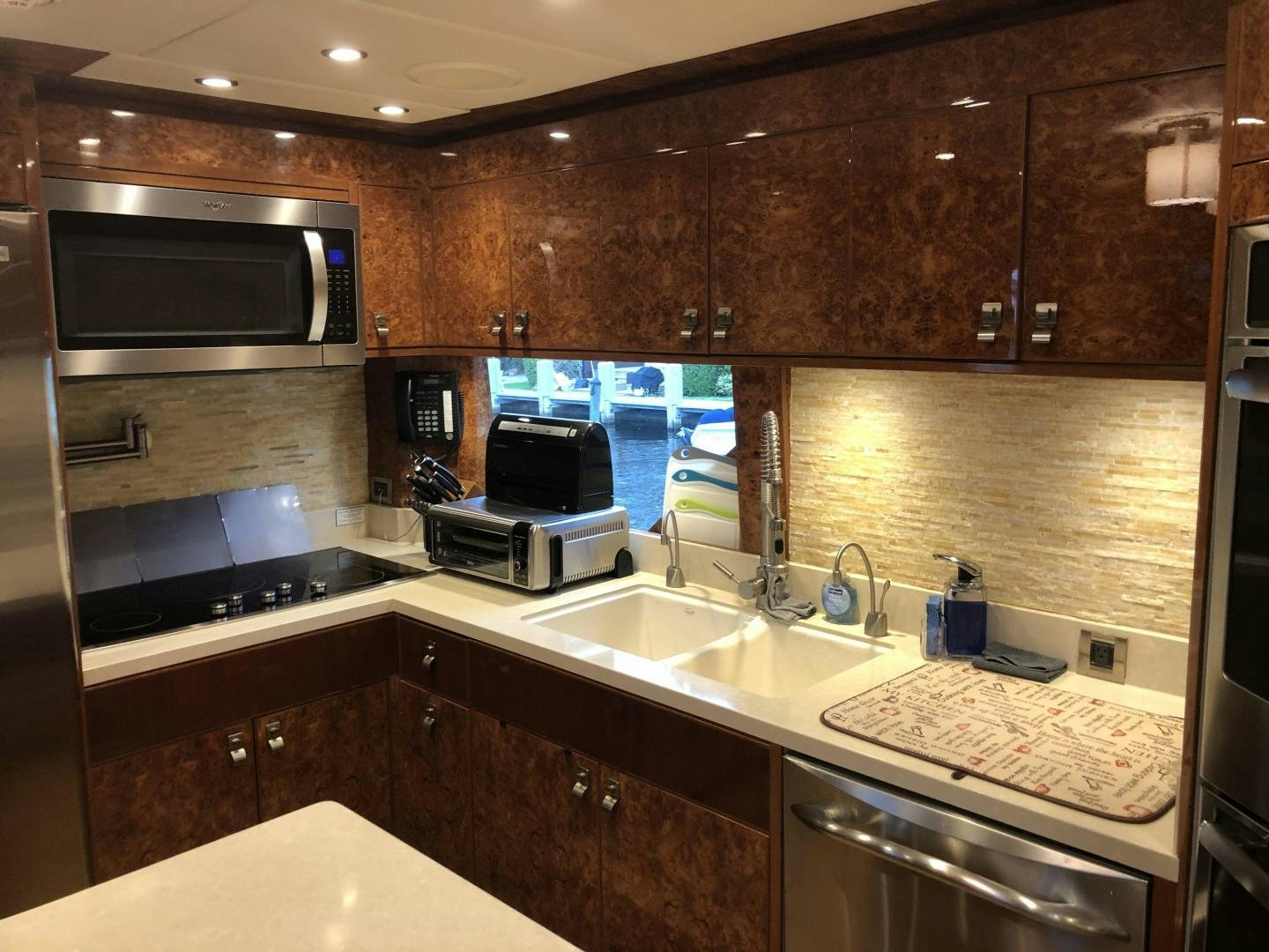 a kitchen with wooden cabinets aboard ADVENTURE US II Yacht for Sale