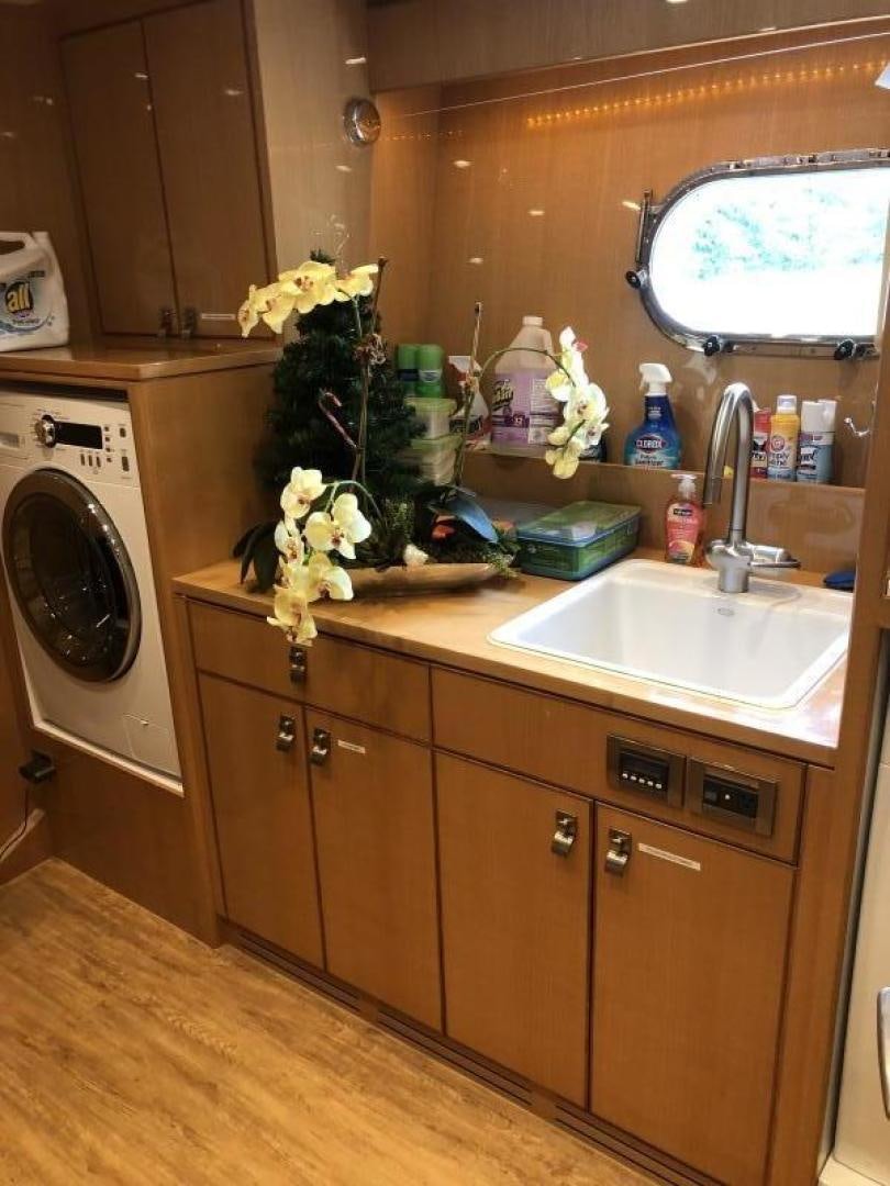 a kitchen with a sink and a washer aboard ADVENTURE US II Yacht for Sale