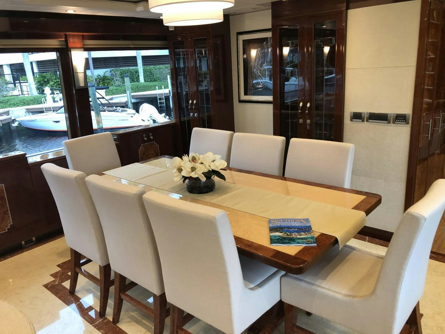 a dining table with chairs and a large window aboard ADVENTURE US II Yacht for Sale