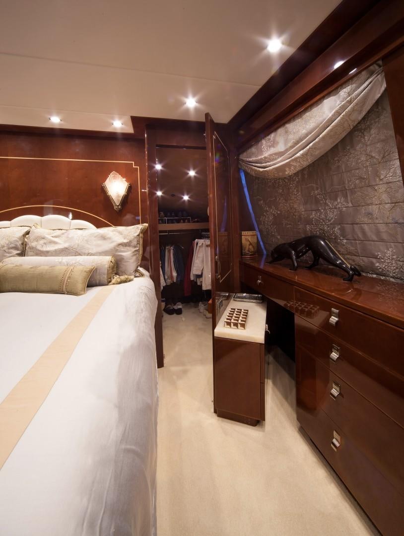 a bedroom with a bed and a desk aboard ADVENTURE US II Yacht for Sale