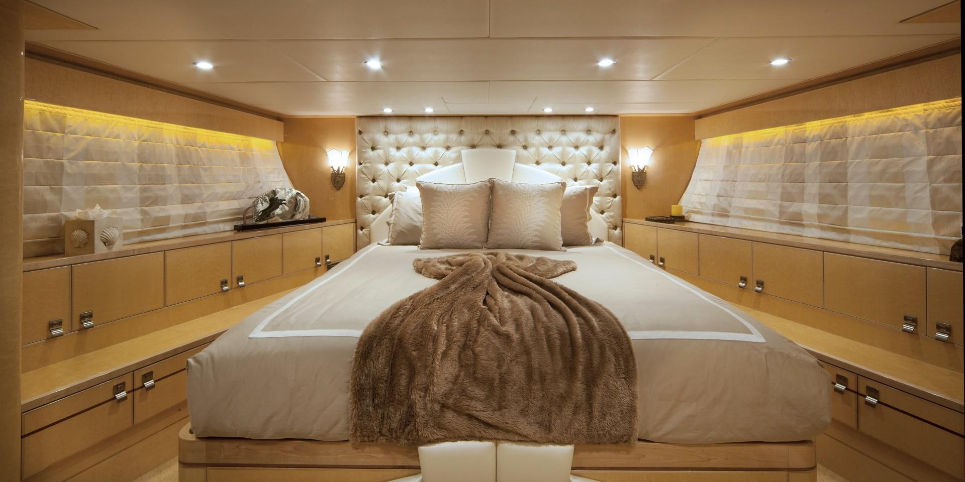 a room with a bed and a dresser aboard ADVENTURE US II Yacht for Sale