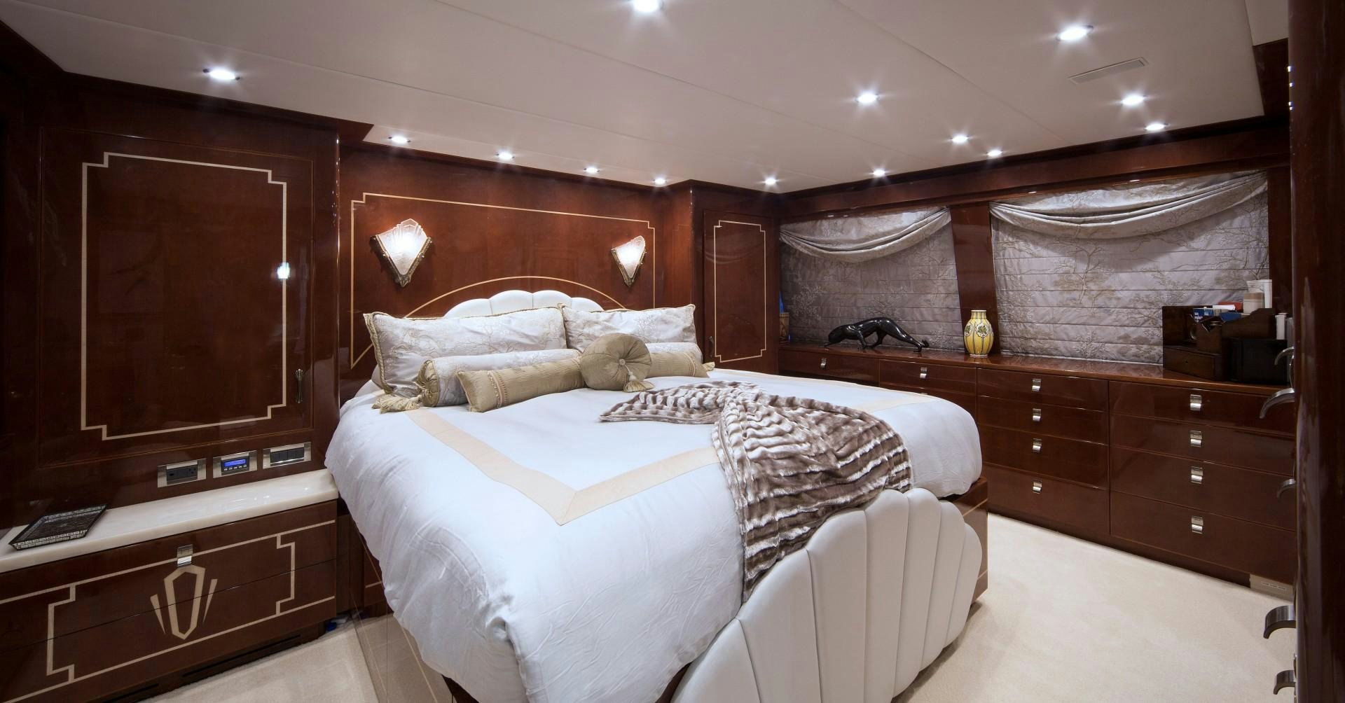 a room with a bed and a desk aboard ADVENTURE US II Yacht for Sale