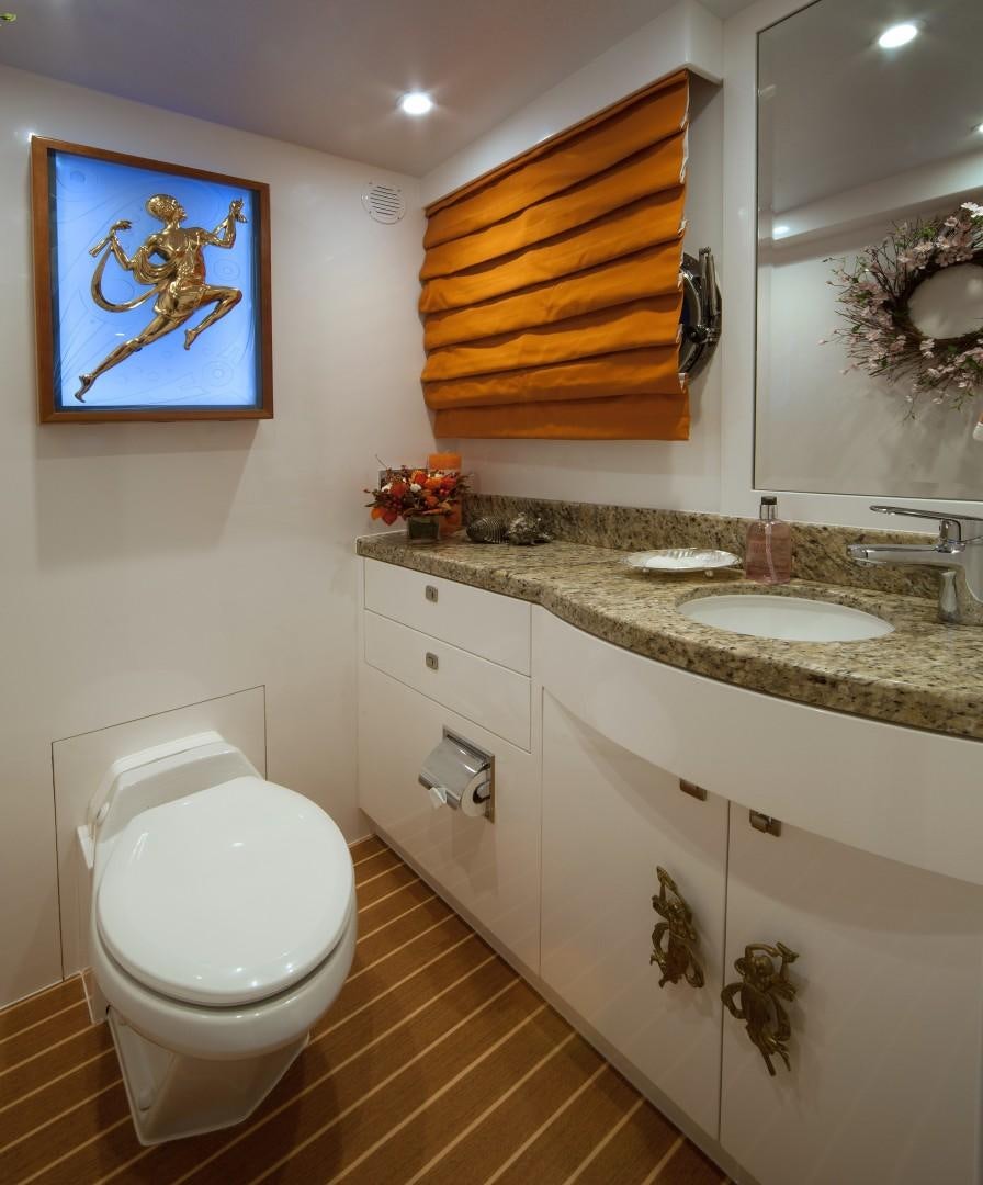 a bathroom with a toilet sink and a mirror aboard ADVENTURE US II Yacht for Sale