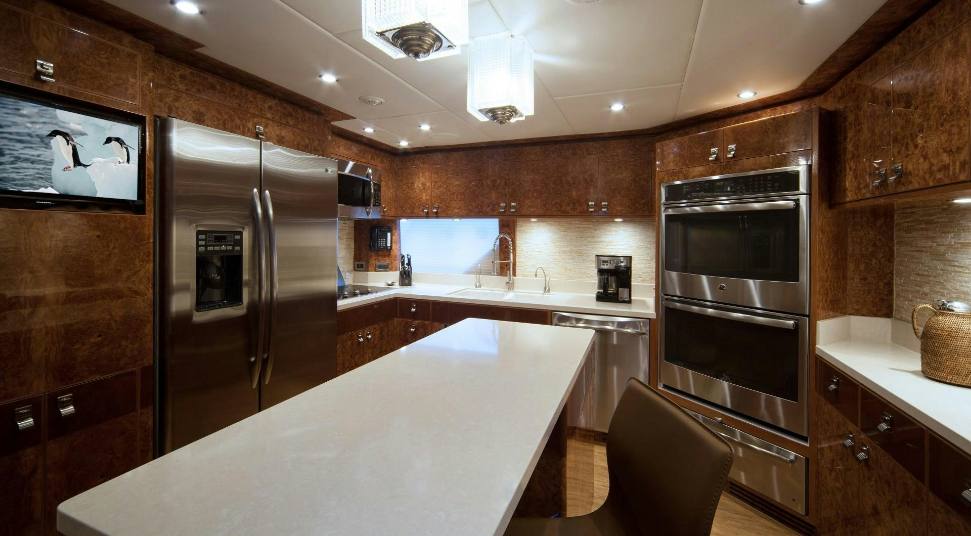 a kitchen with a large island aboard ADVENTURE US II Yacht for Sale