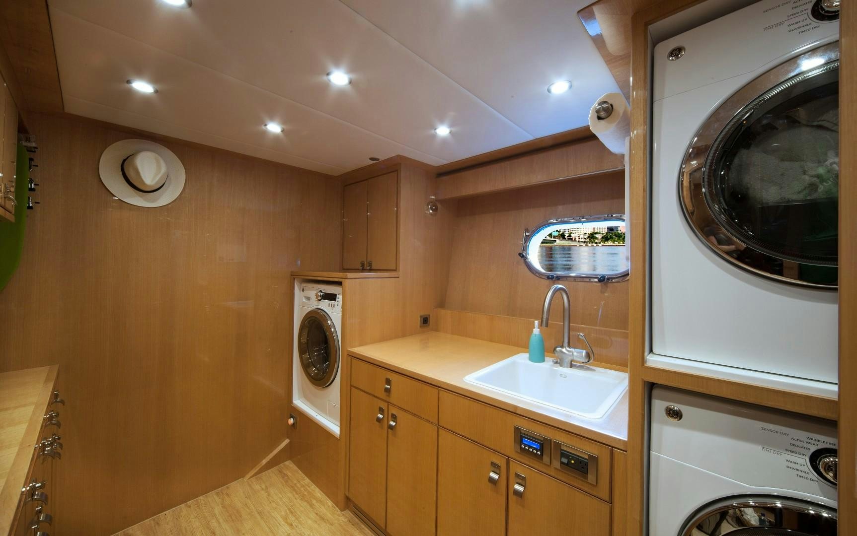 a kitchen with a sink and a washing machine aboard ADVENTURE US II Yacht for Sale