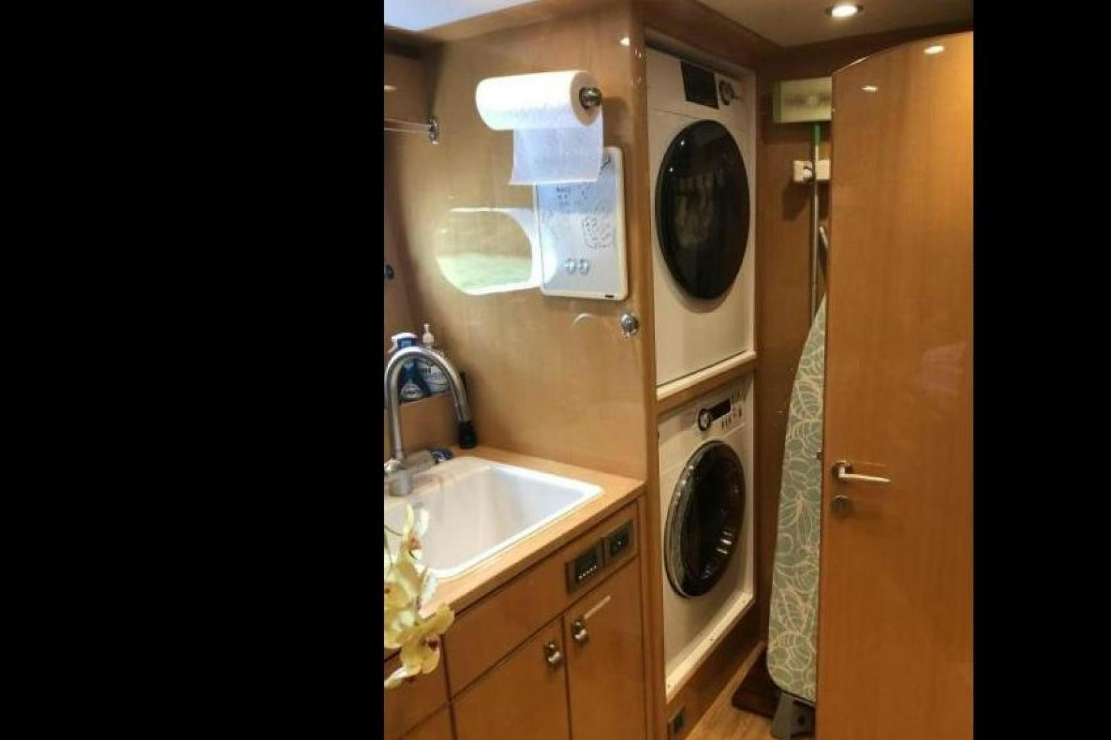 a bathroom with a washing machine aboard ADVENTURE US II Yacht for Sale