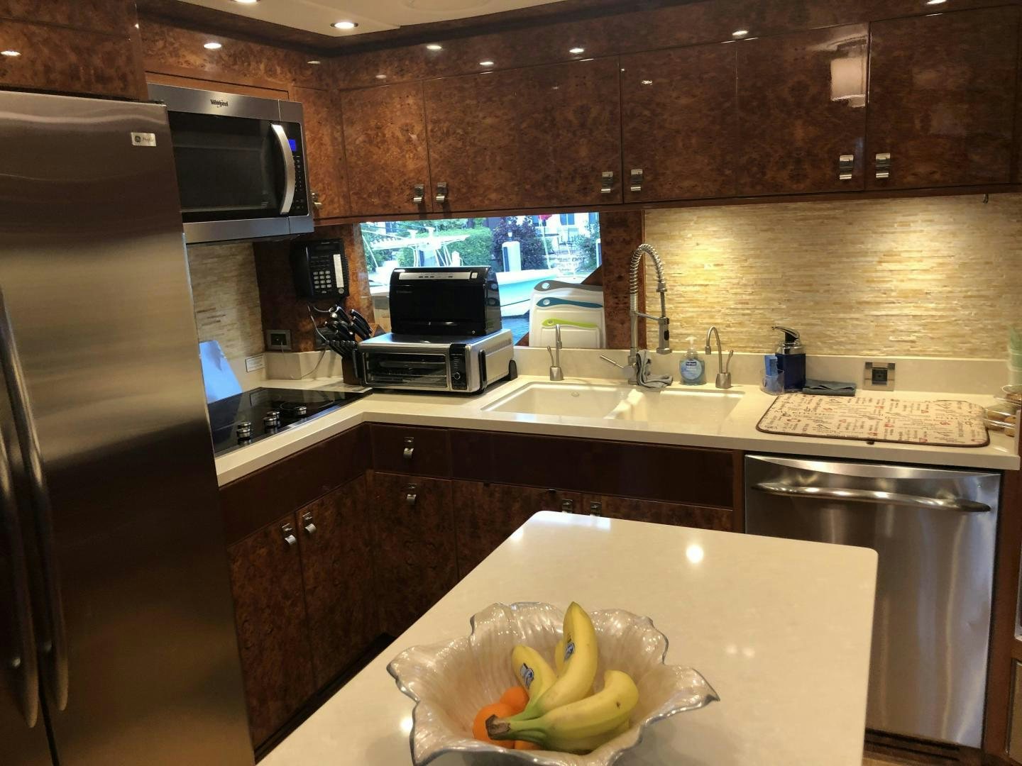 a kitchen with a microwave oven and a sink aboard ADVENTURE US II Yacht for Sale