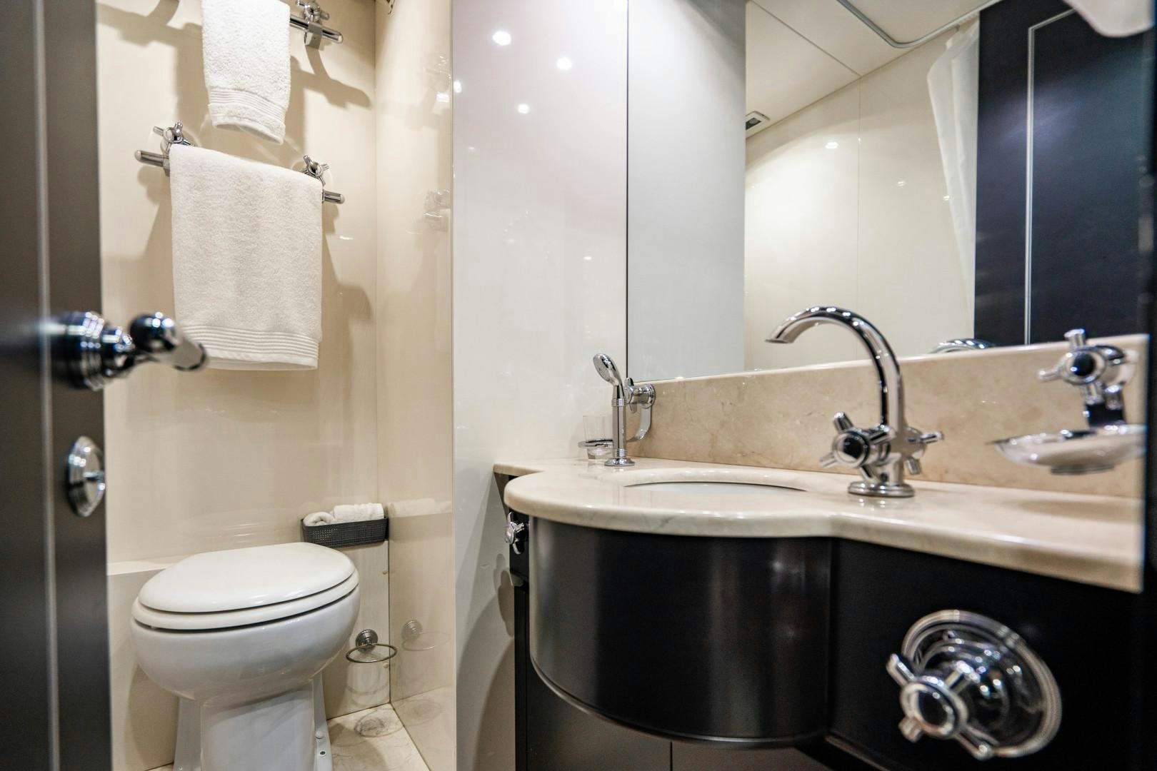a bathroom with a sink and a toilet aboard IV GIOCARE Yacht for Sale