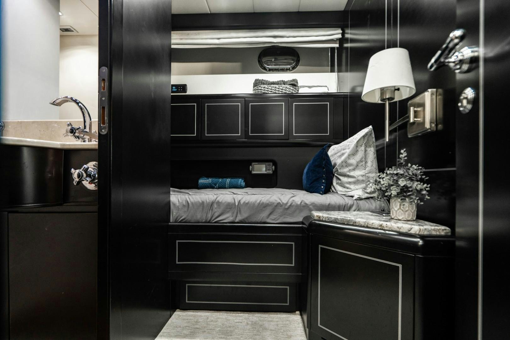 a room with a bed and a lamp aboard IV GIOCARE Yacht for Sale