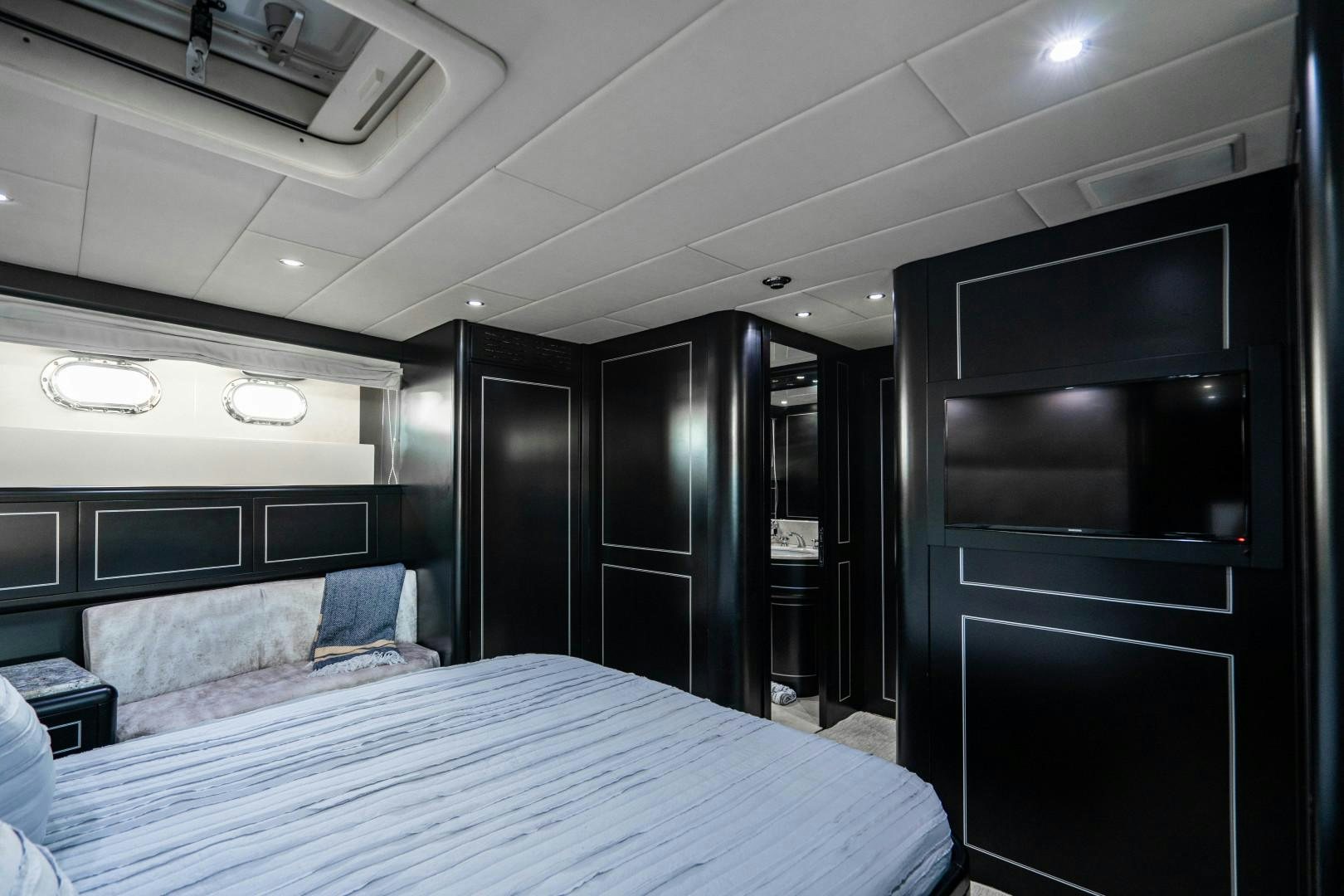 a room with a bed and a television aboard IV GIOCARE Yacht for Sale