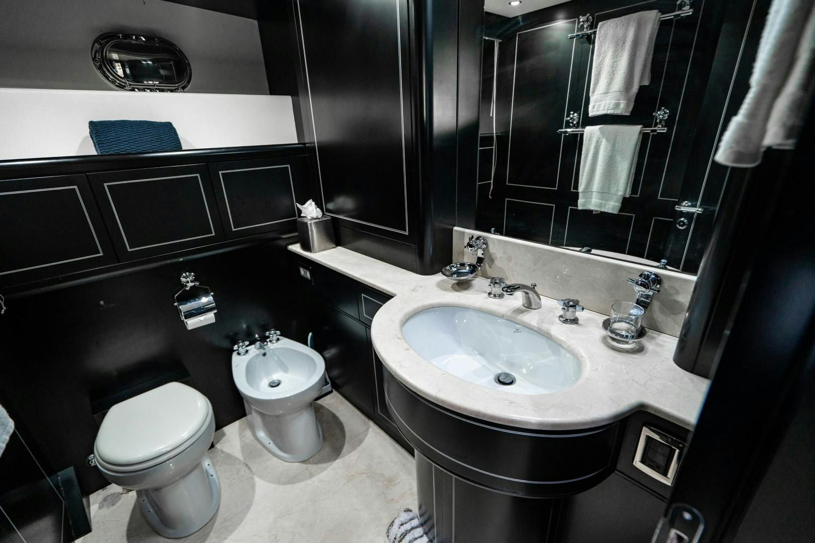 a bathroom with a sink and a toilet aboard IV GIOCARE Yacht for Sale
