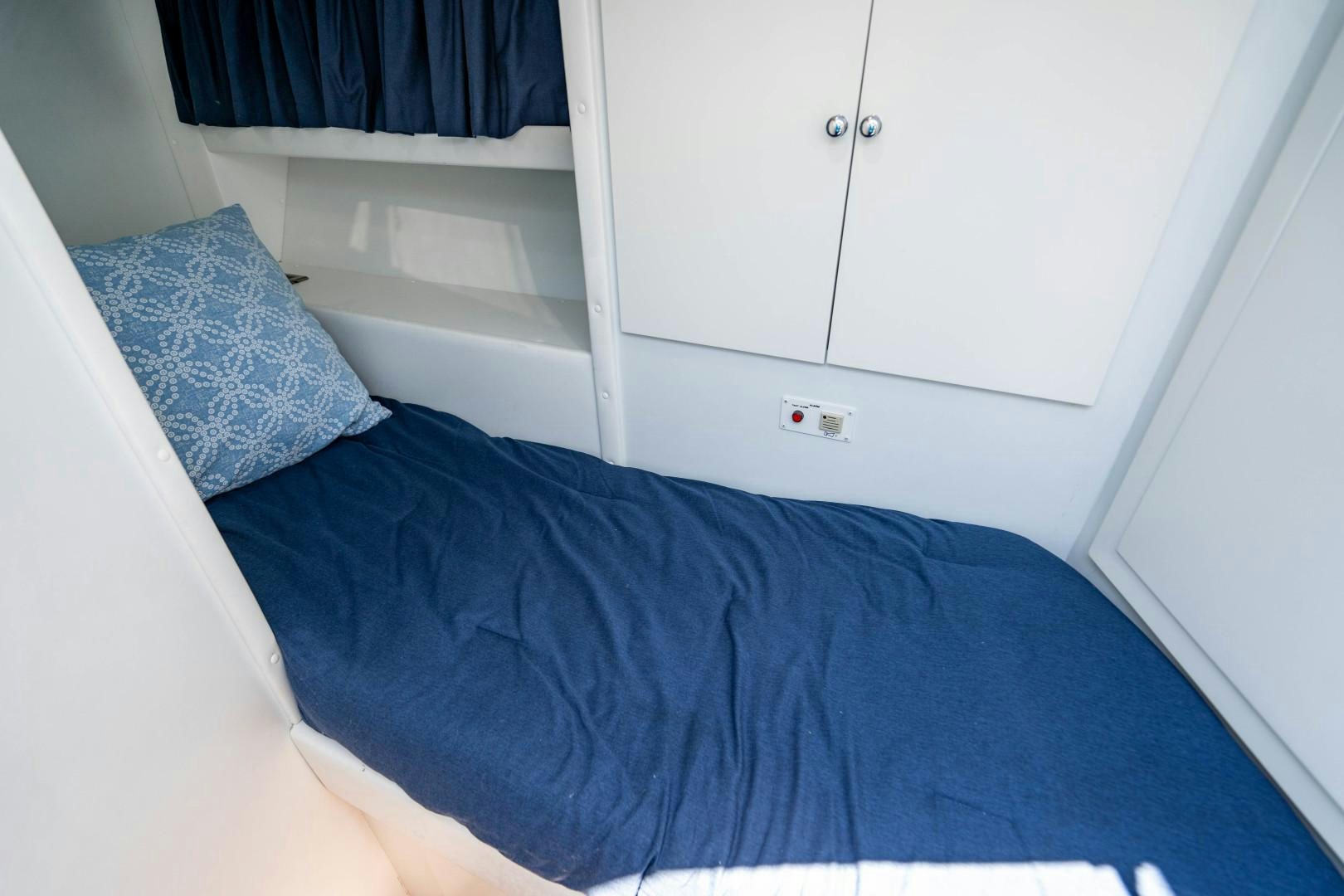 a blue blanket on a bed aboard IV GIOCARE Yacht for Sale