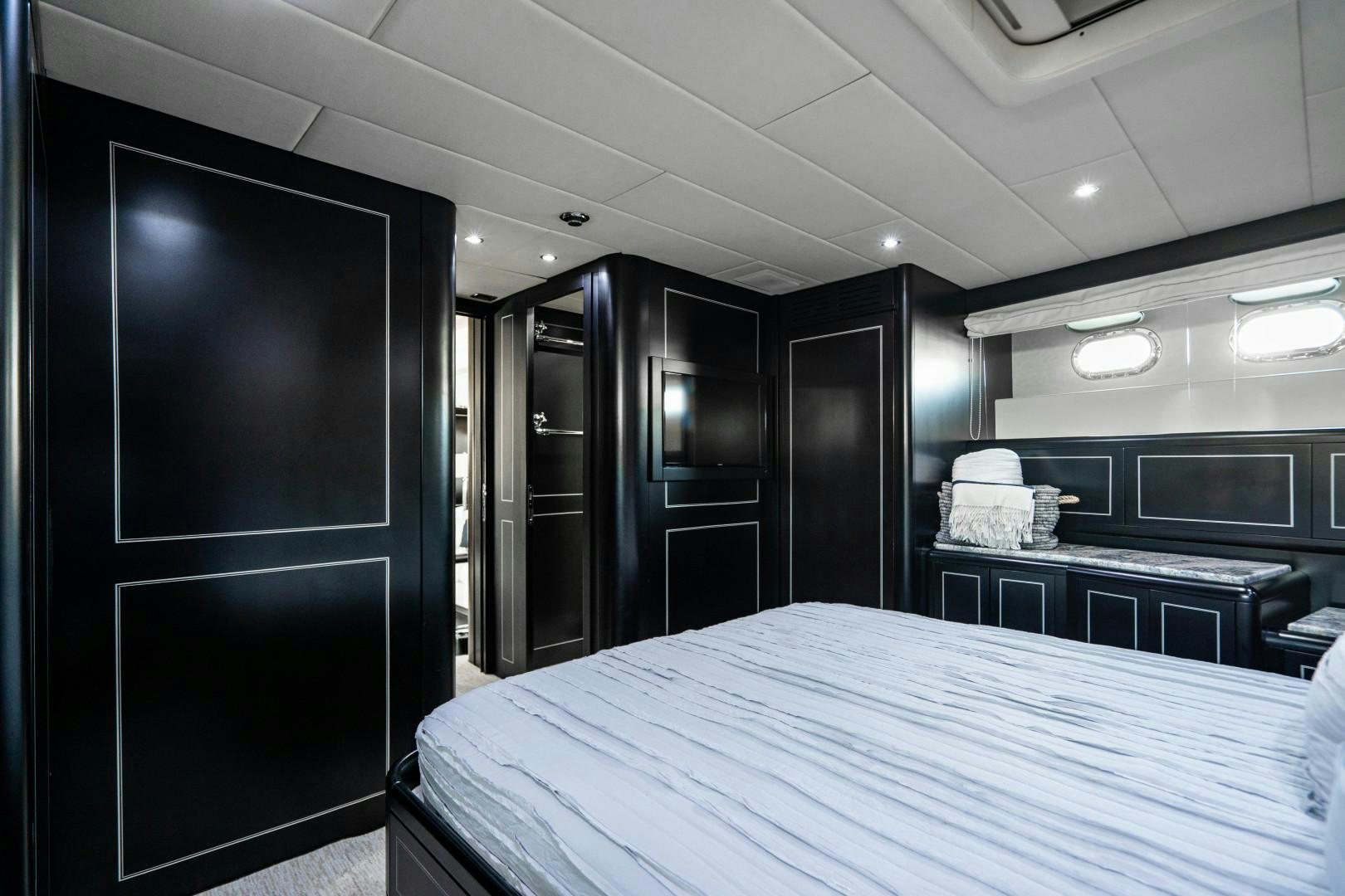 a room with a bed and a desk aboard IV GIOCARE Yacht for Sale
