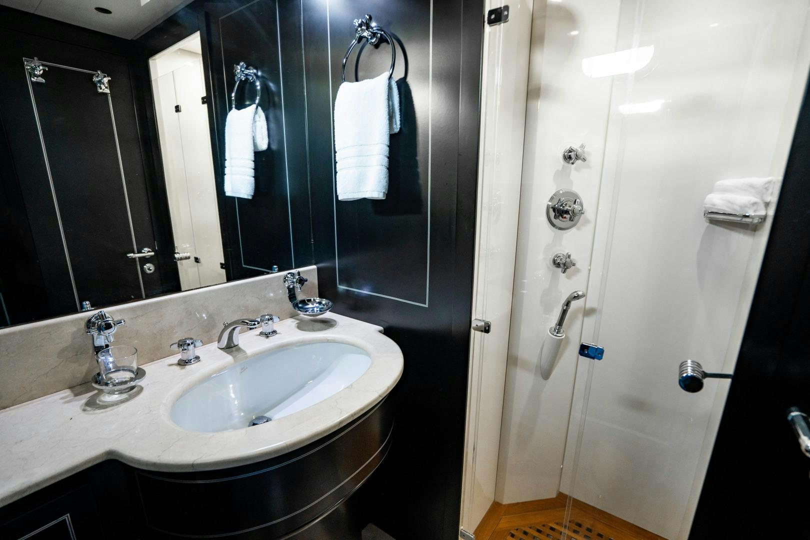 a bathroom with a sink and a mirror aboard IV GIOCARE Yacht for Sale