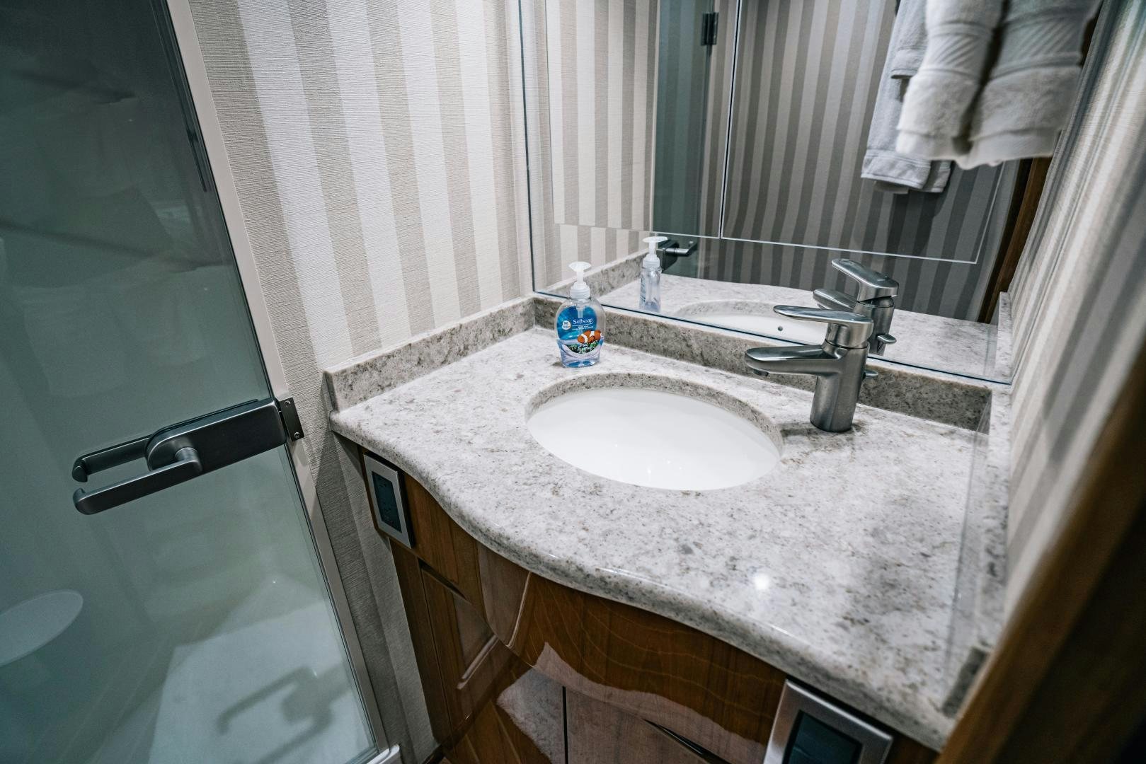 a bathroom with a sink and a mirror aboard SUNSHINE Yacht for Sale