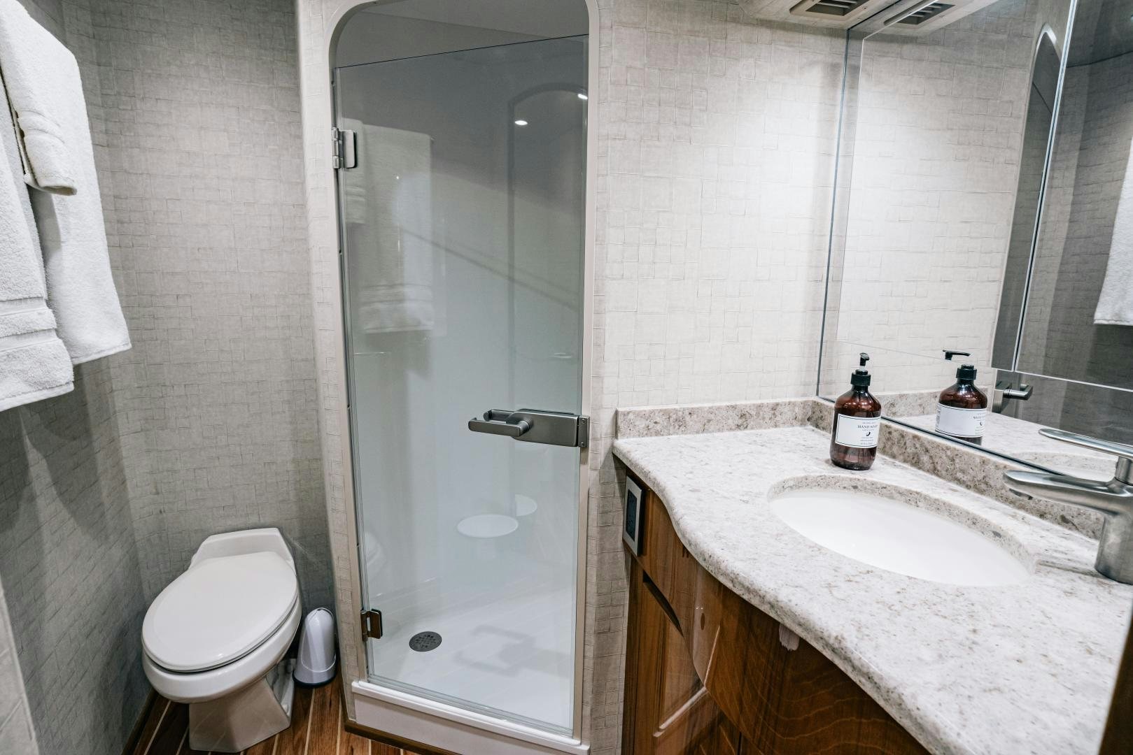 a bathroom with a glass shower door aboard SUNSHINE Yacht for Sale