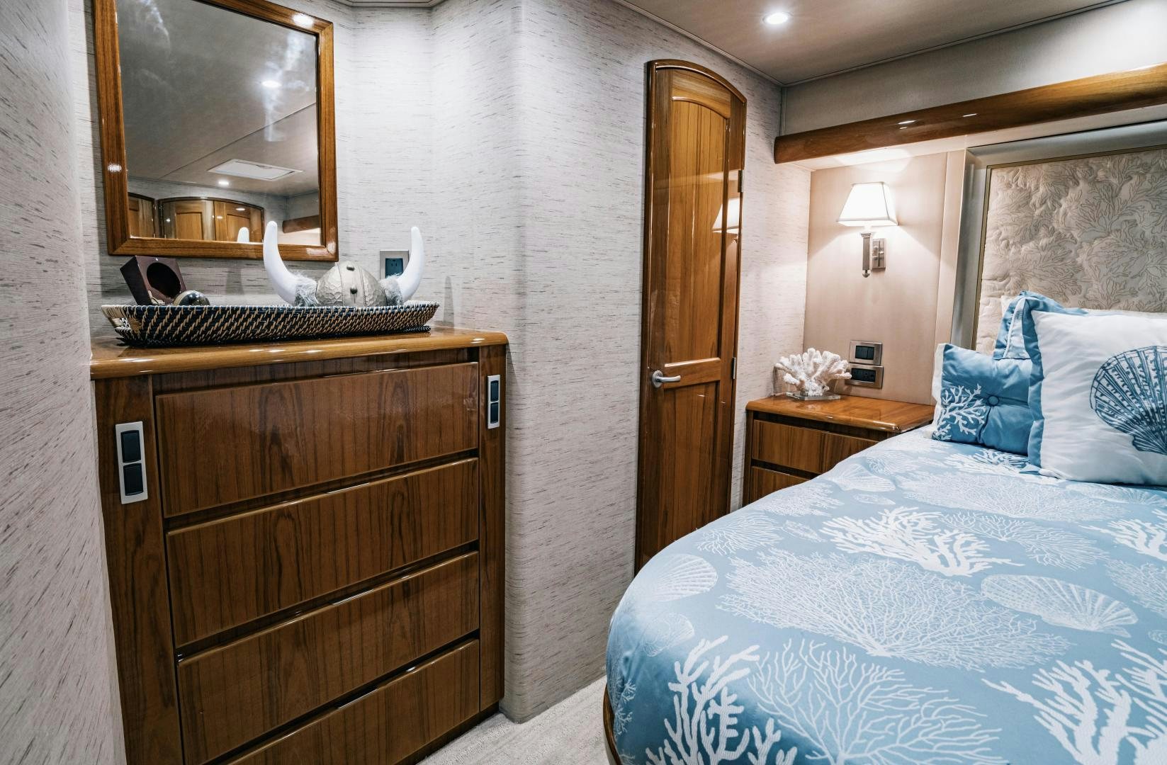 a bedroom with a bed and a dresser aboard SUNSHINE Yacht for Sale