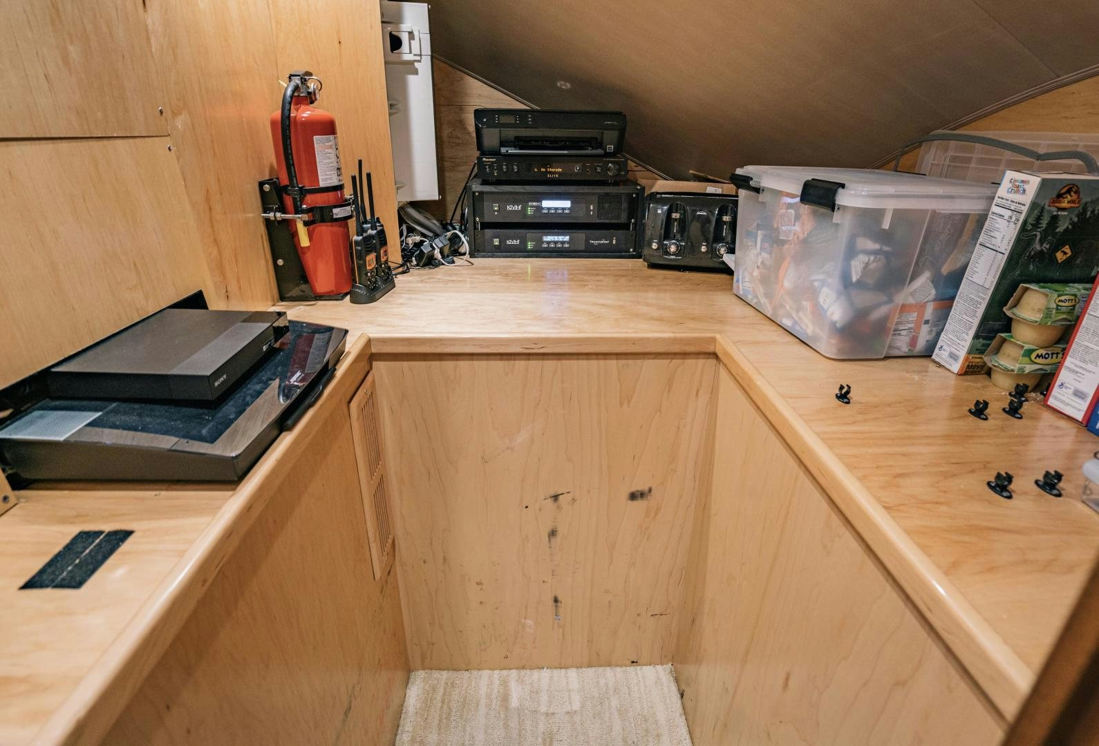 a wooden desk with a computer and other objects on it aboard SUNSHINE Yacht for Sale