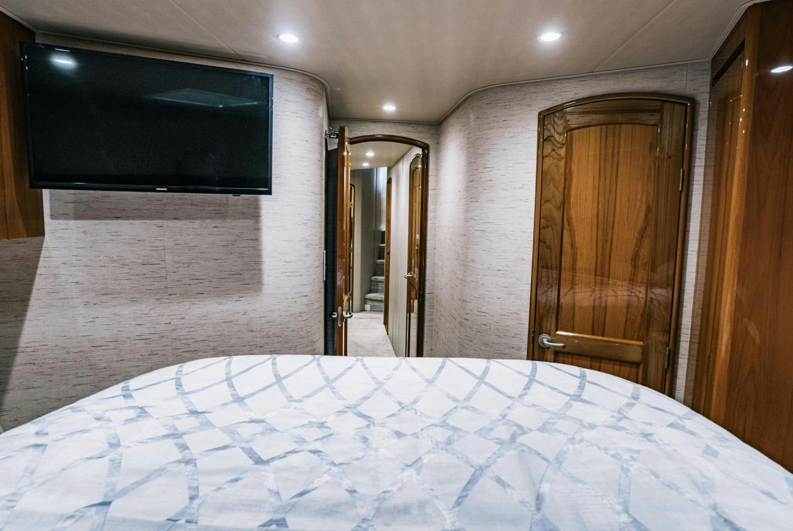 a bed with a television on the wall aboard SUNSHINE Yacht for Sale