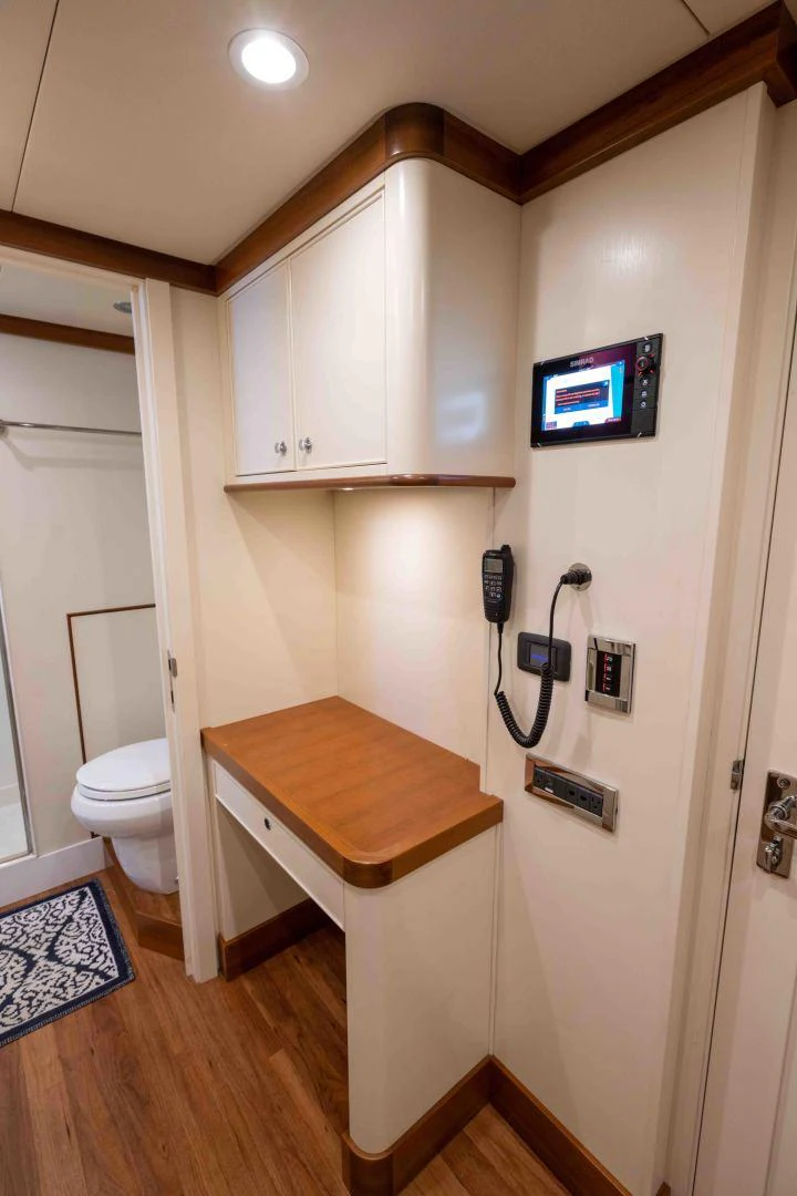 a small bathroom with a tv on the wall aboard NEREUS Yacht for Sale