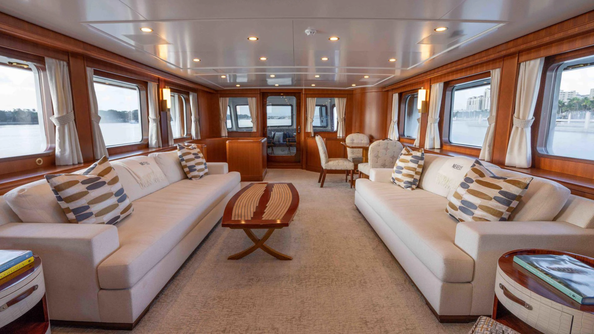 a living room with a couch and a table aboard NEREUS Yacht for Sale