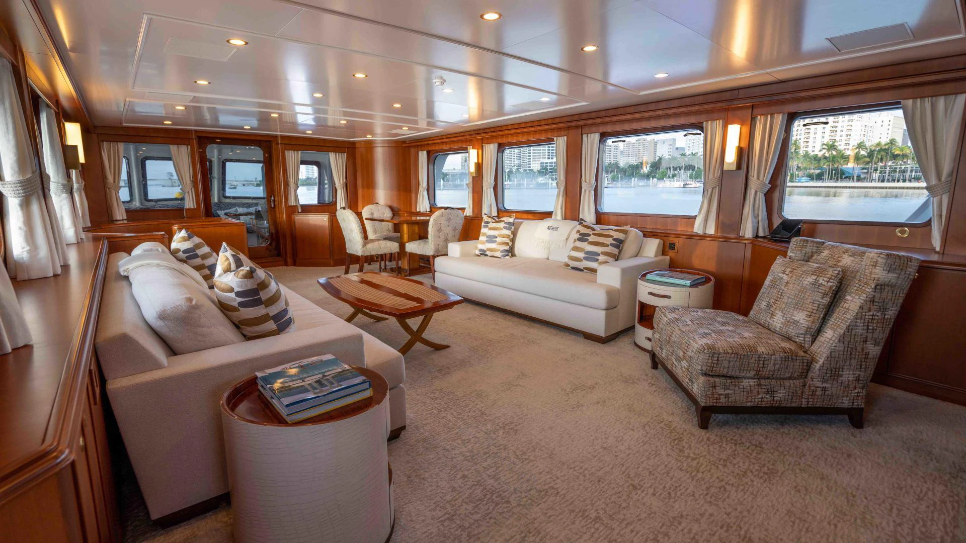 a living room with a couch and a table aboard NEREUS Yacht for Sale