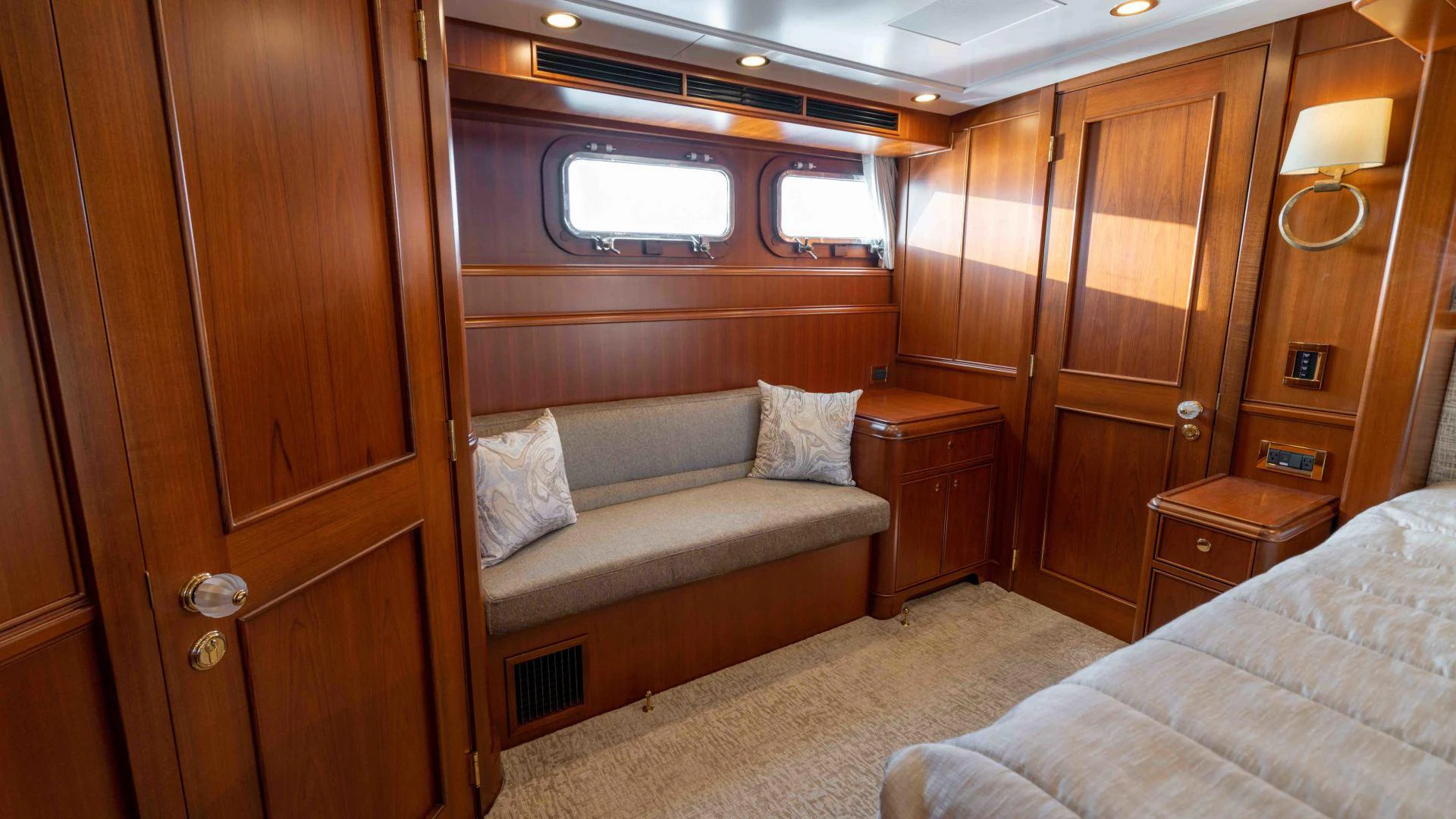 a room with a bed and a wooden cabinet aboard NEREUS Yacht for Sale