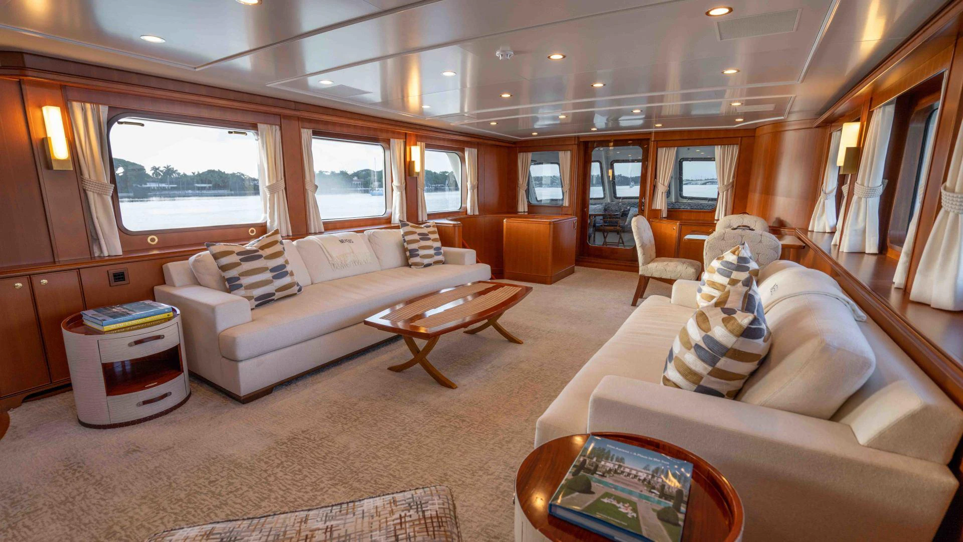 a living room with a couch and a coffee table aboard NEREUS Yacht for Sale