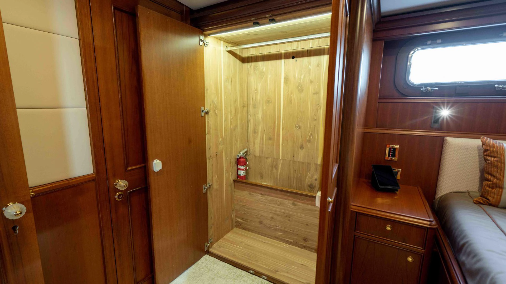 a room with a bed and a wood door aboard NEREUS Yacht for Sale