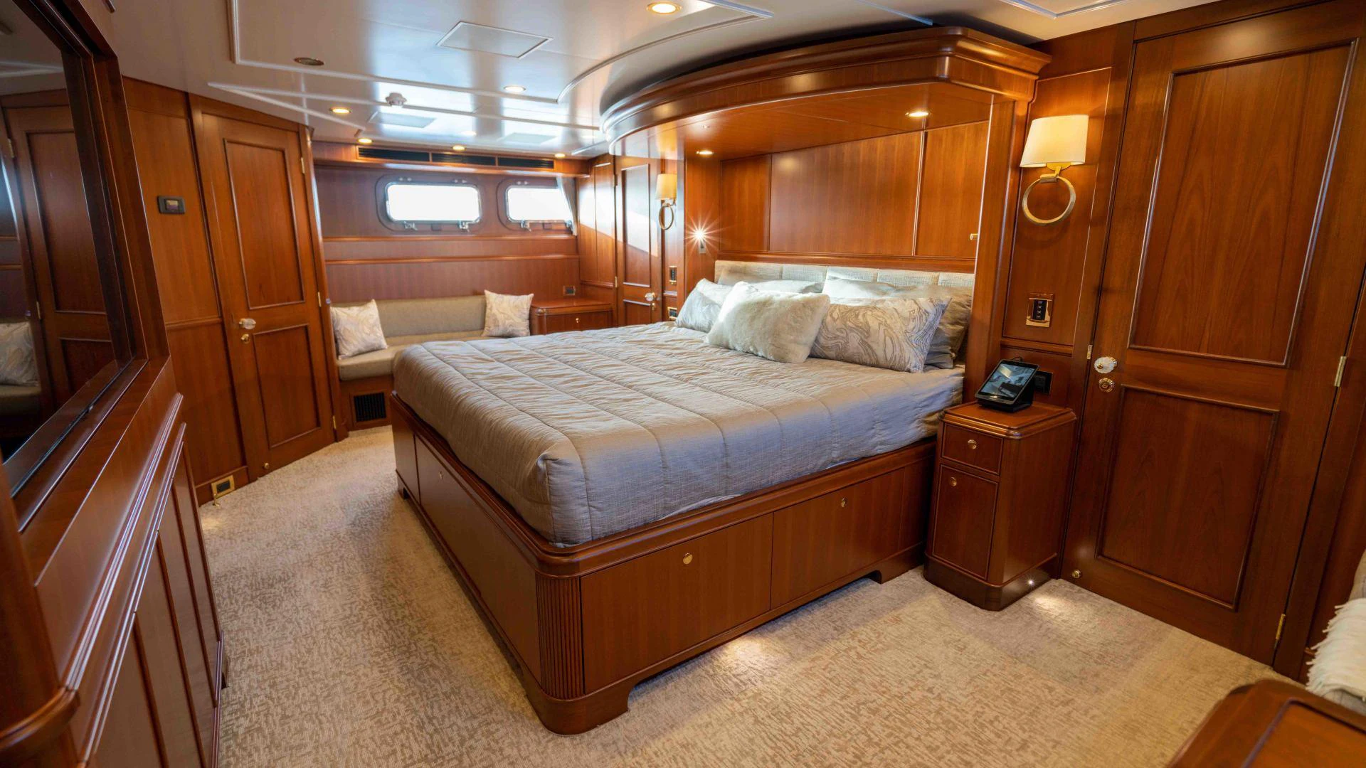 a bedroom with a bed and a dresser aboard NEREUS Yacht for Sale