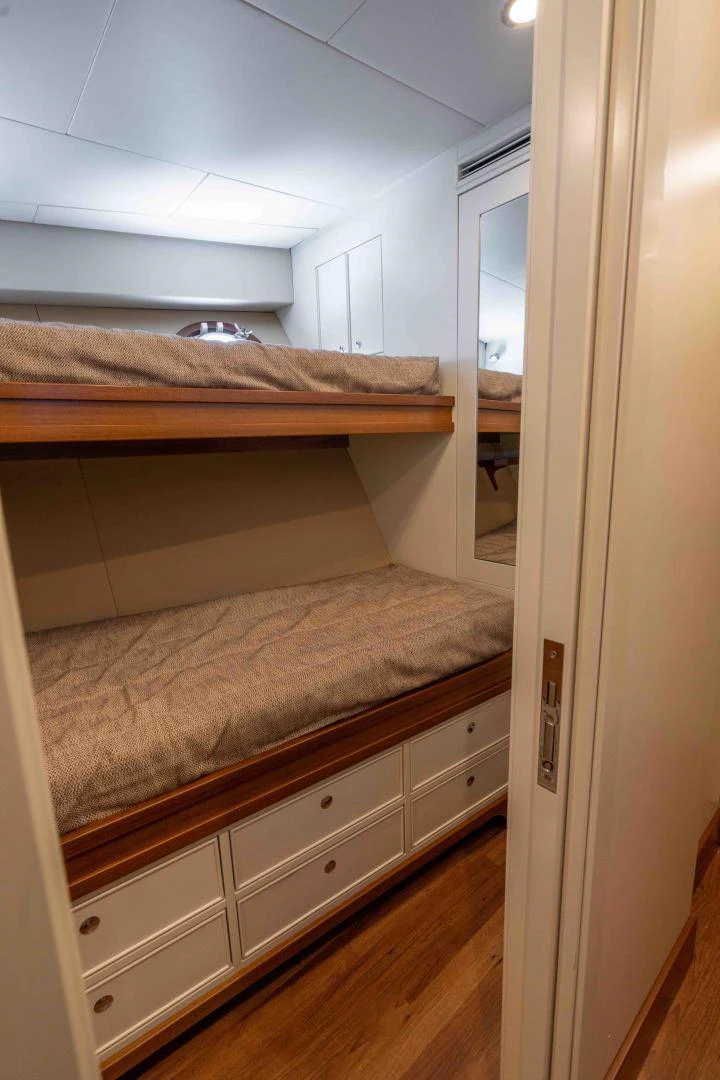 a bedroom with a wood floor aboard NEREUS Yacht for Sale