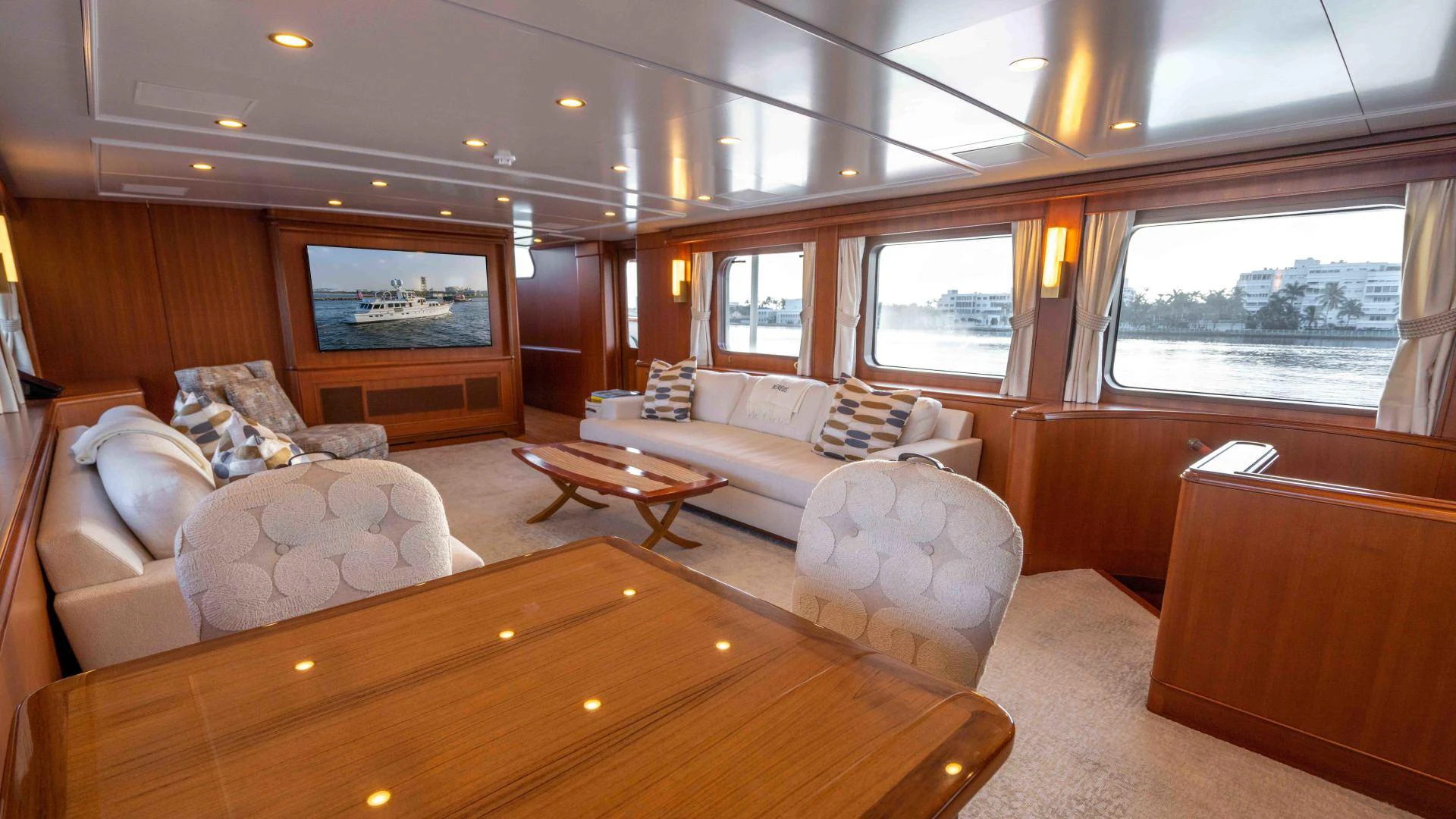 a living room with a couch and a table aboard NEREUS Yacht for Sale
