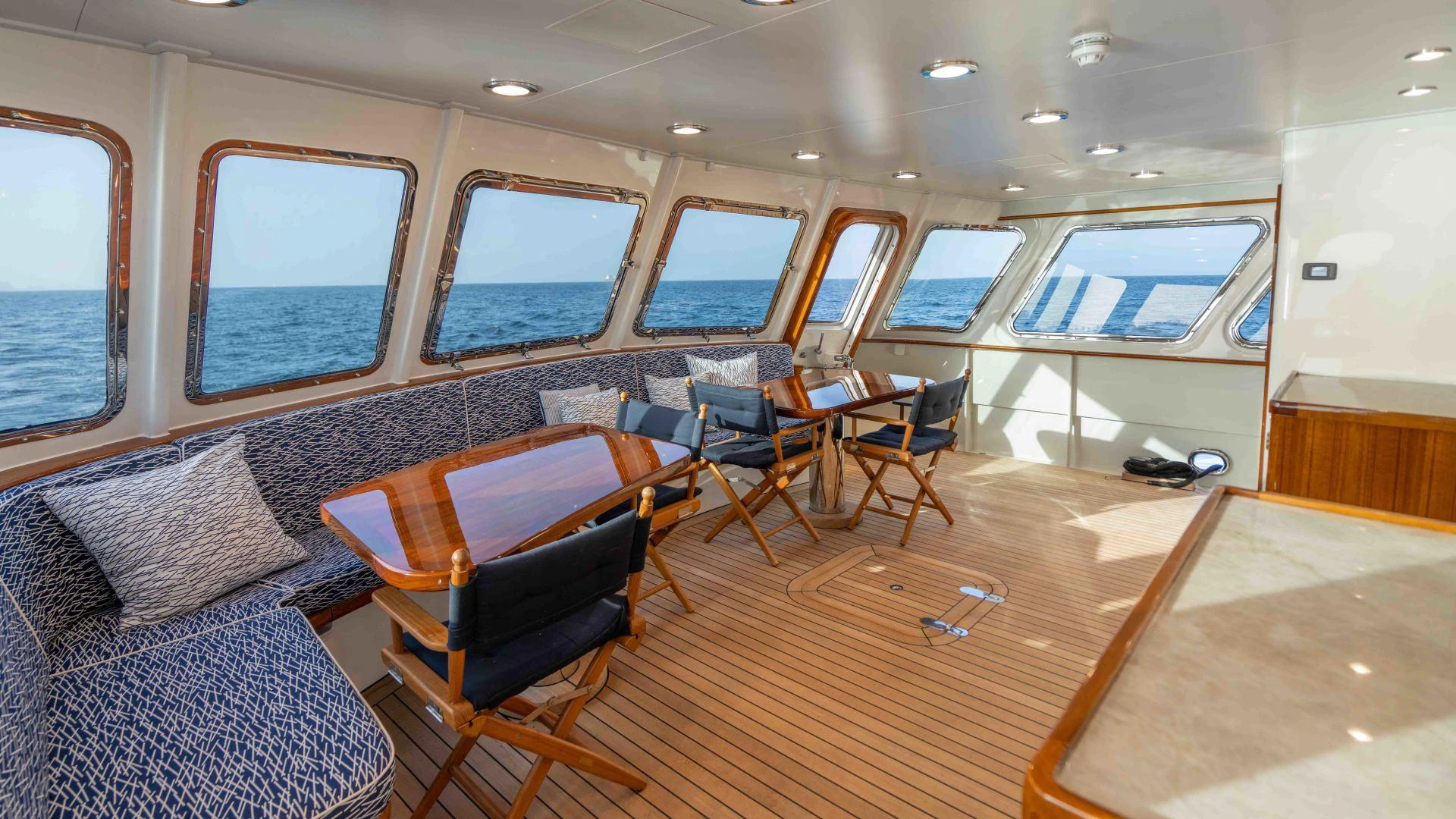 a room with a couch and chairs aboard NEREUS Yacht for Sale