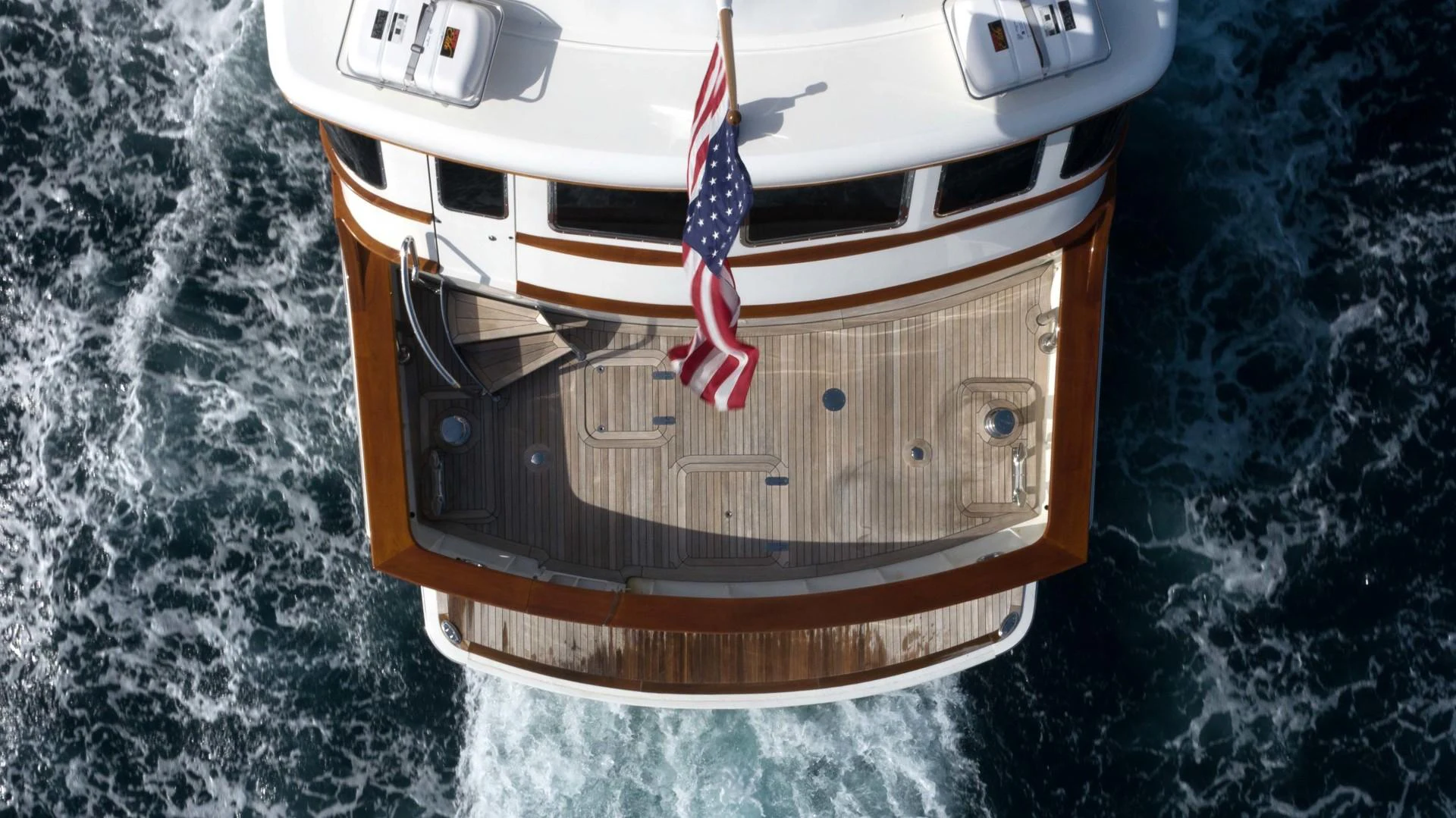 a white car with a flag on it aboard NEREUS Yacht for Sale