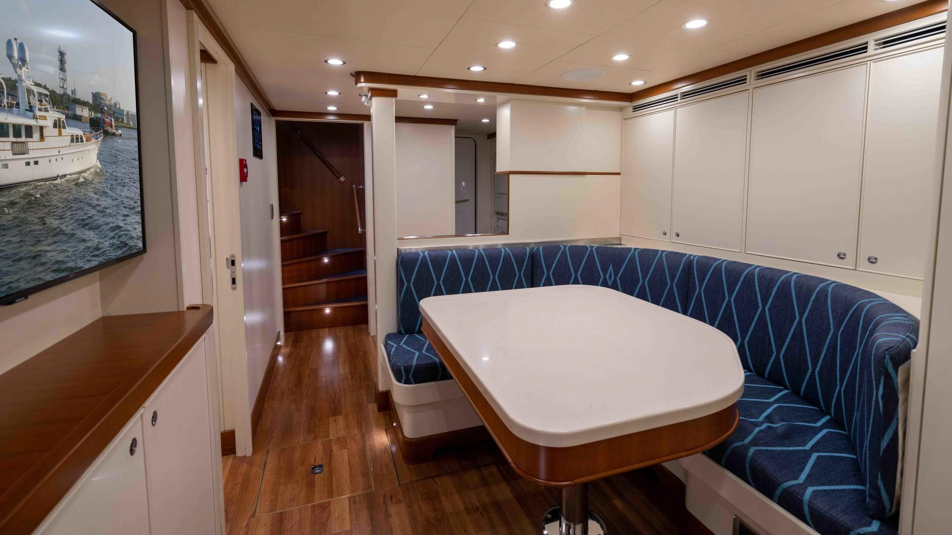 a large white table in a room aboard NEREUS Yacht for Sale