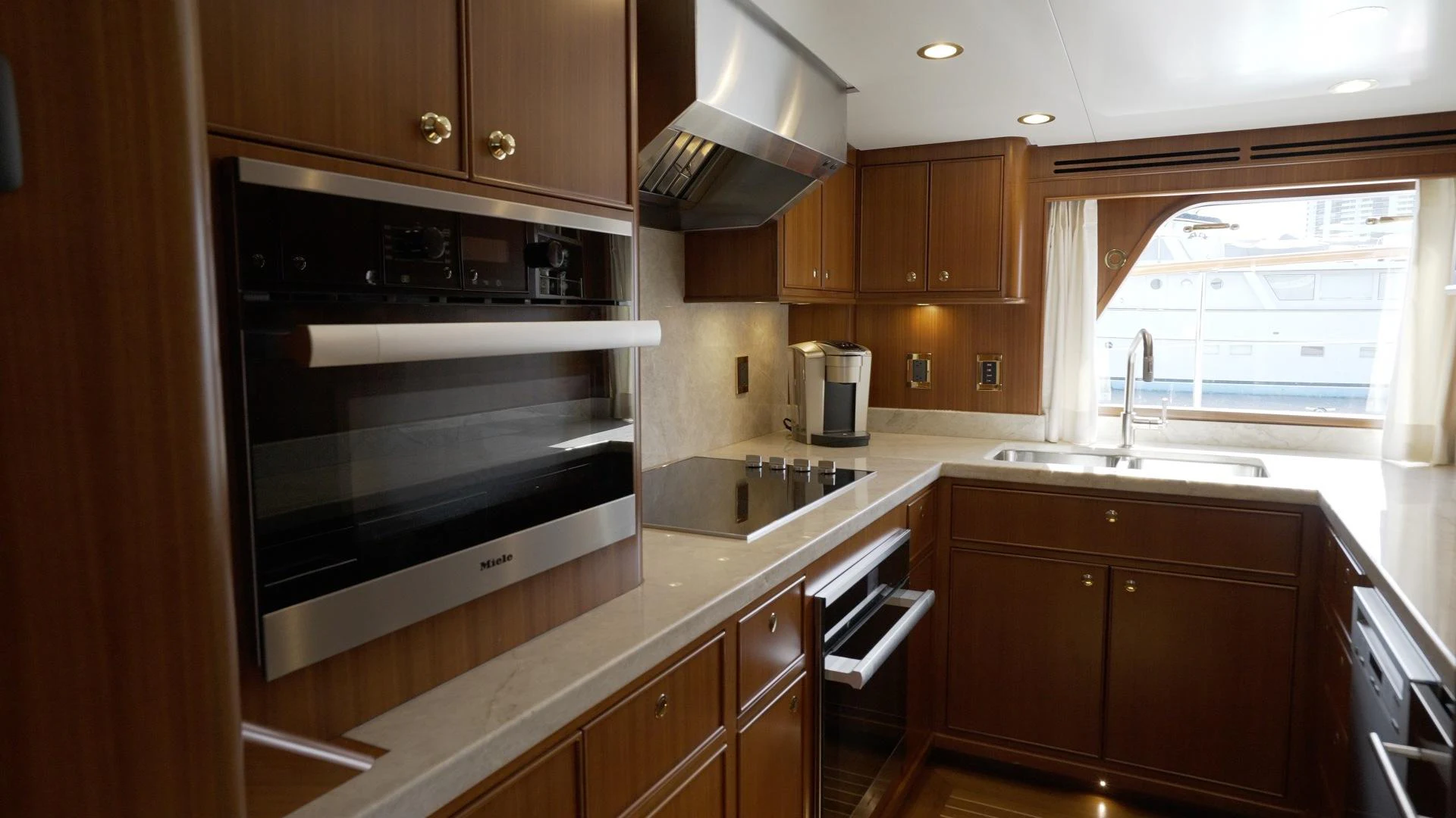 a kitchen with wooden cabinets aboard NEREUS Yacht for Sale