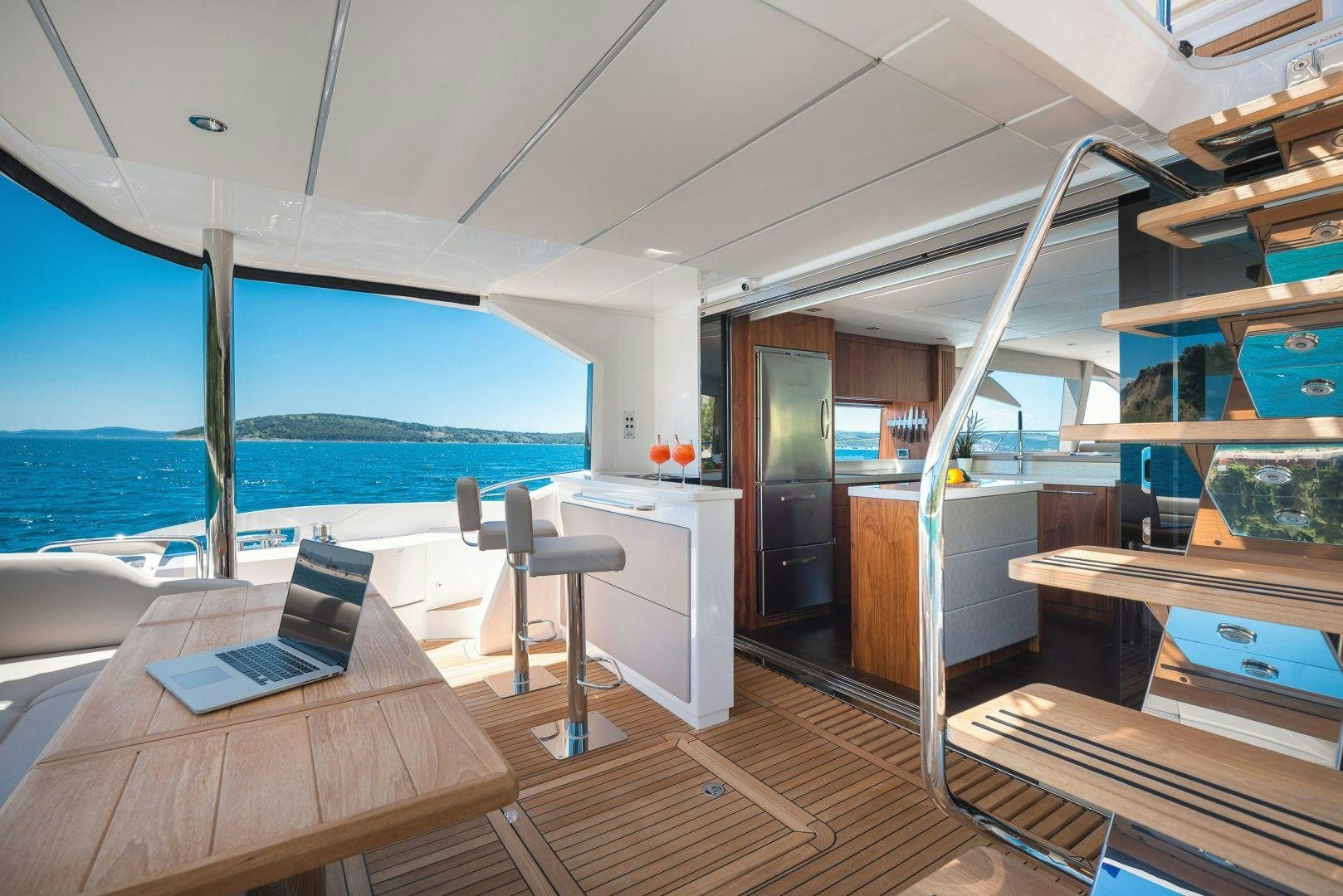 a room with a laptop and a table and chairs aboard HIDEAWAY Yacht for Sale