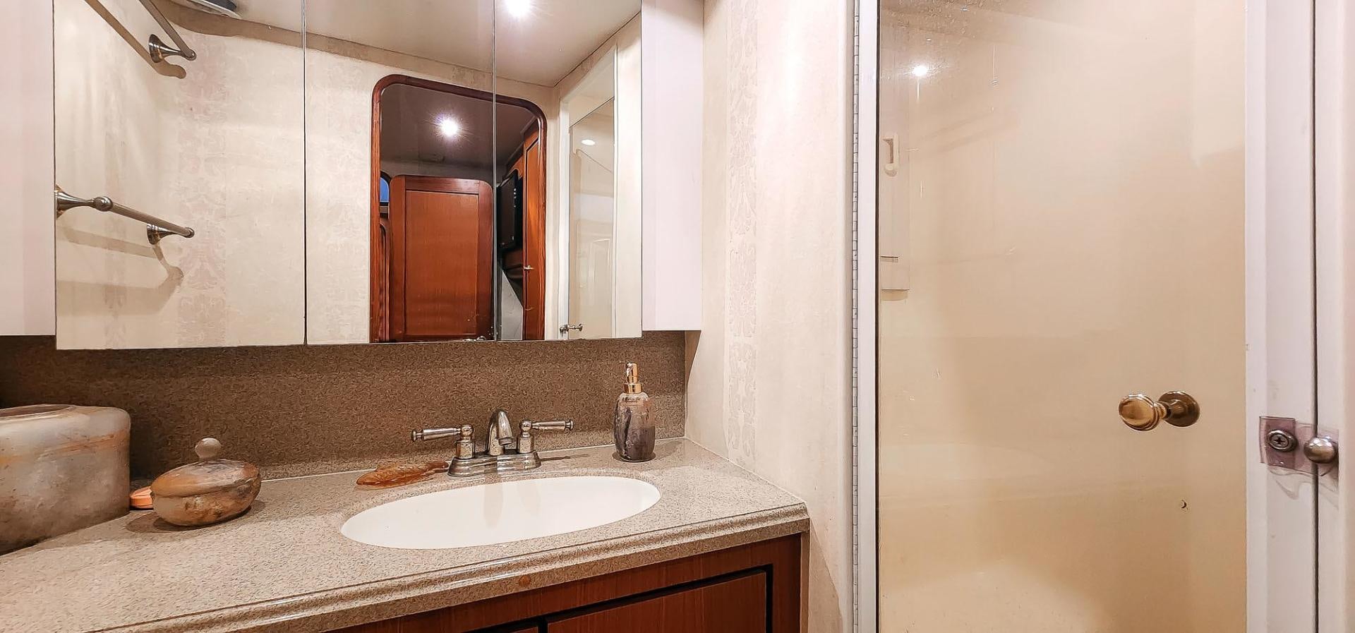 a bathroom with a large mirror aboard My Time Yacht for Sale