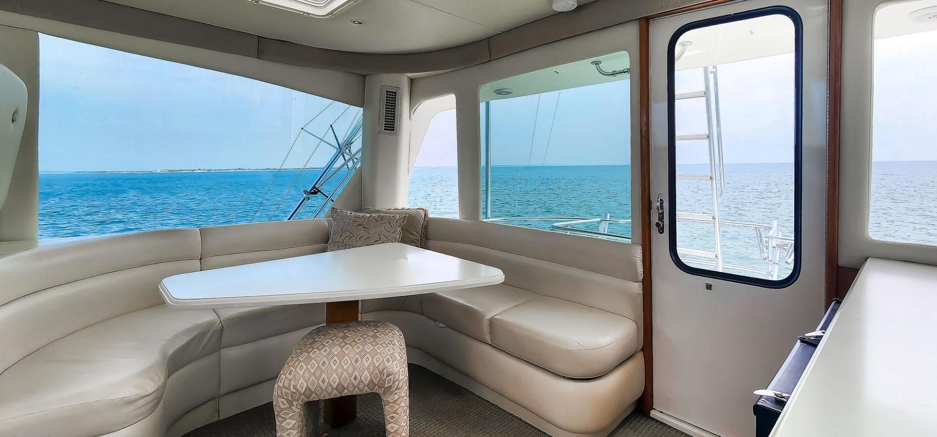 a room with a bed and a table aboard My Time Yacht for Sale
