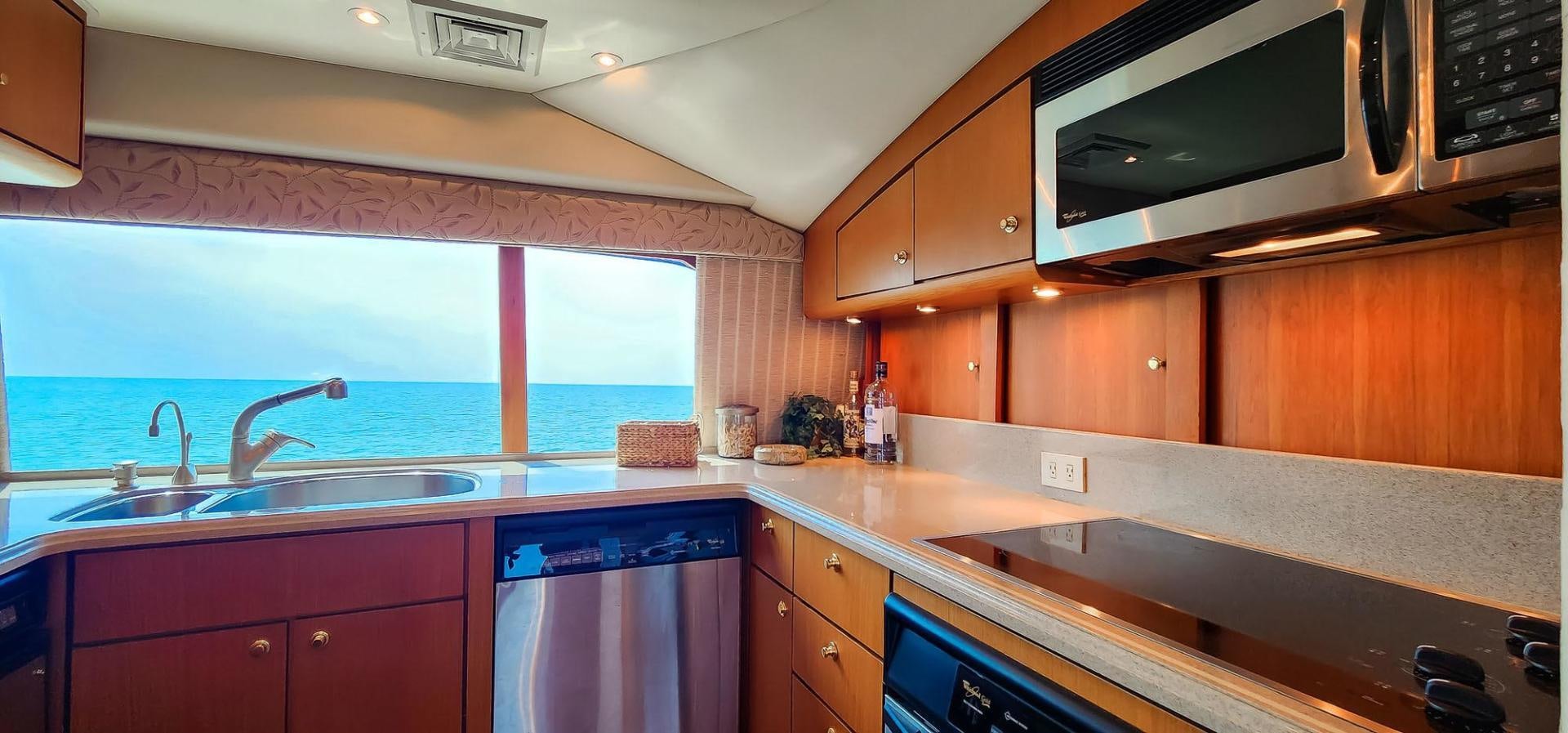 a kitchen with a microwave oven and a sink aboard My Time Yacht for Sale