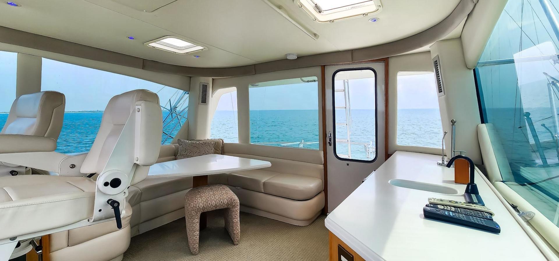 a white airplane with a desk and a computer on it aboard My Time Yacht for Sale