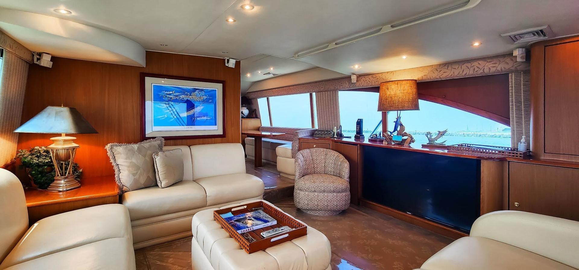 a living room with a couch and a table aboard My Time Yacht for Sale