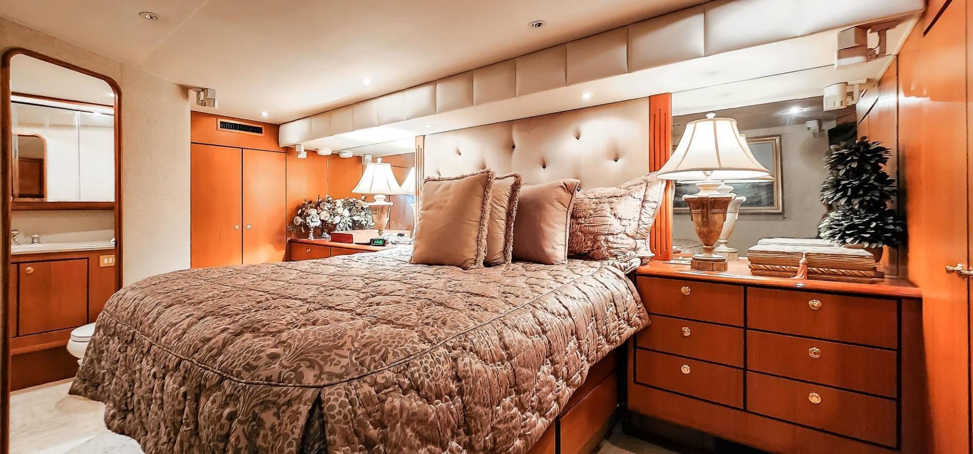 a bedroom with a large bed aboard My Time Yacht for Sale